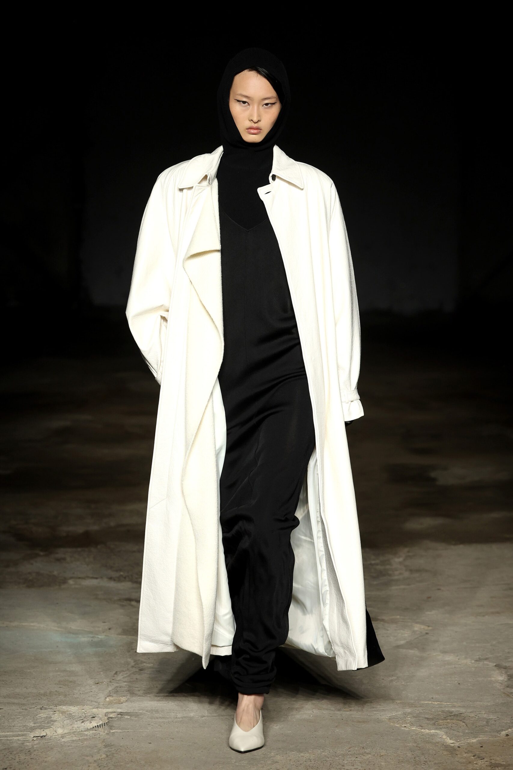 white wool coat with black jumpsuit