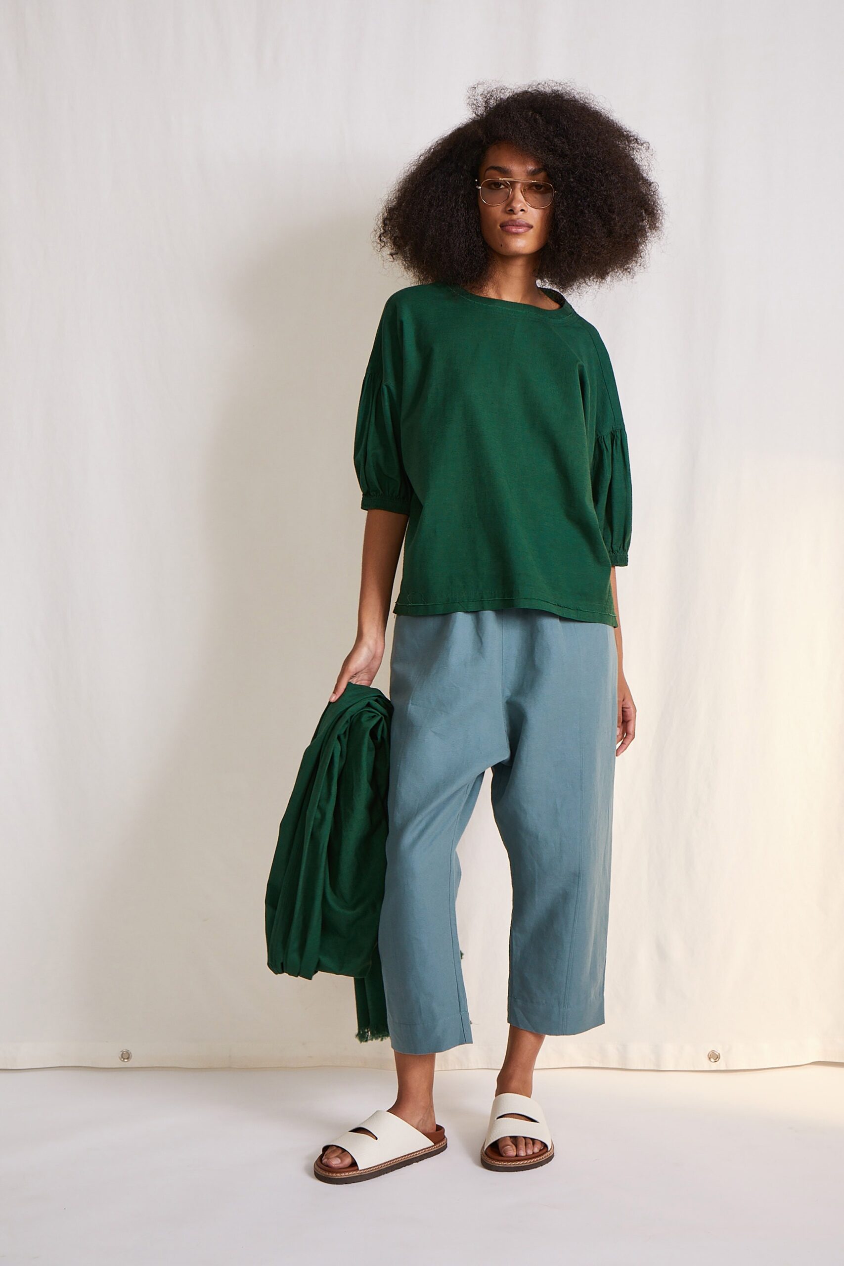 green relaxed top with blue pants