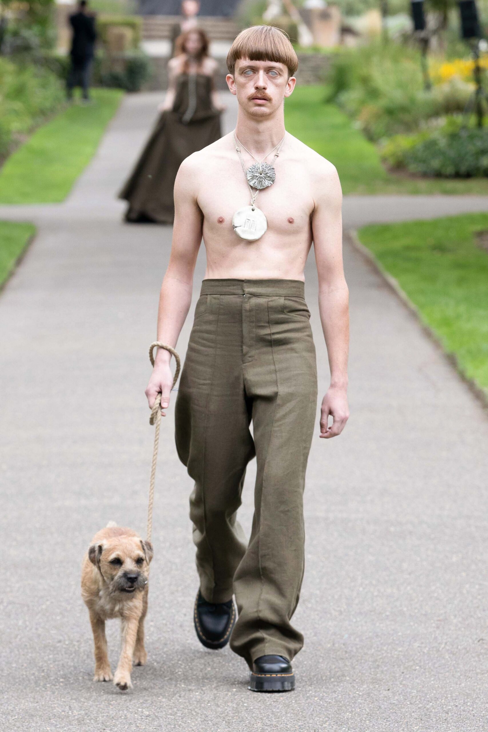 green relaxed pants with black shoes