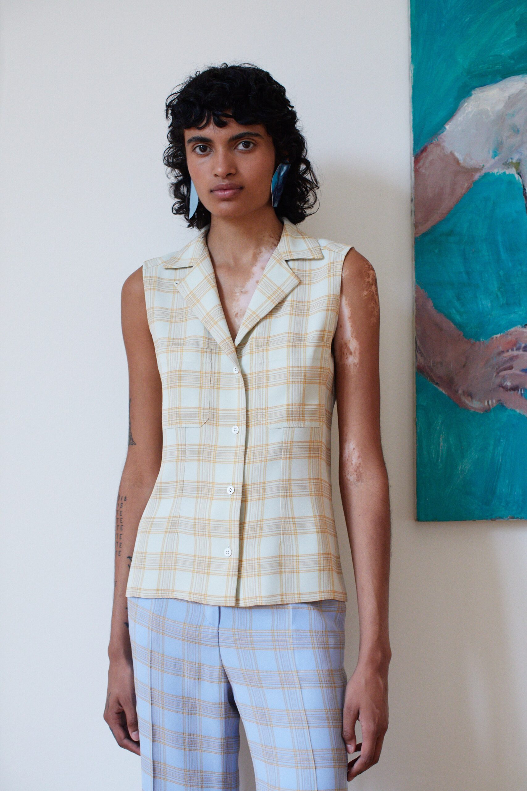 checked sleeveless top and slim pants