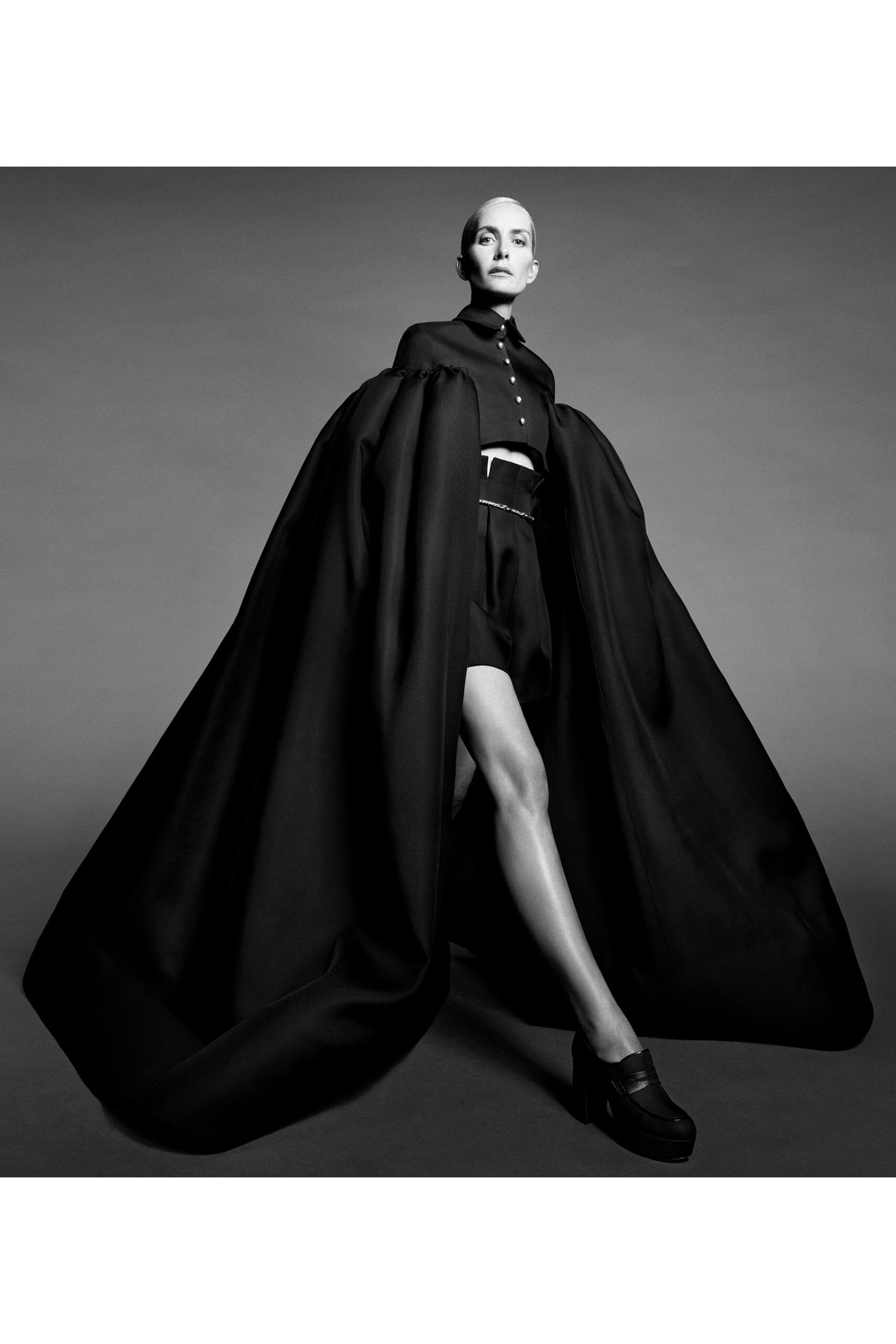 black structured cape and fitted shorts