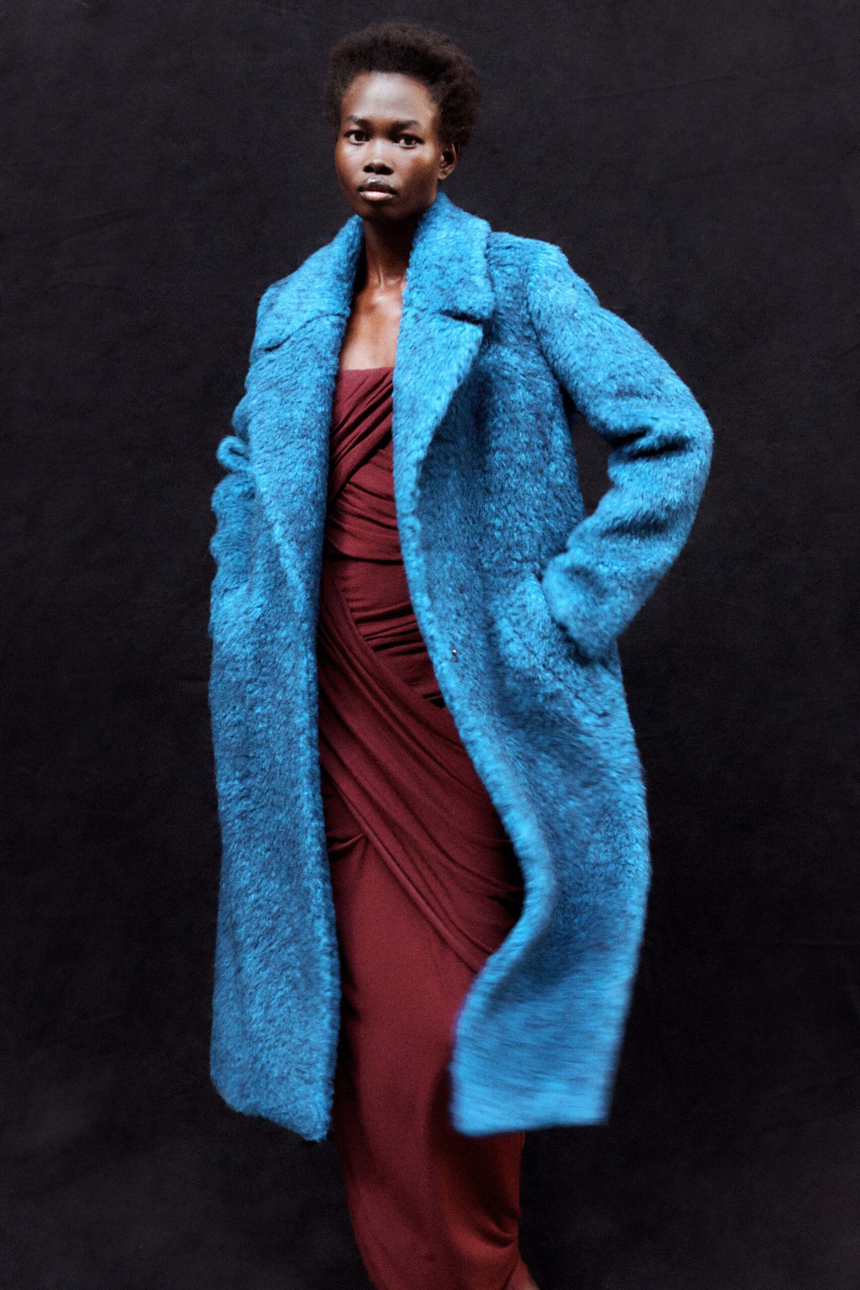blue faux-fur coat and red dress