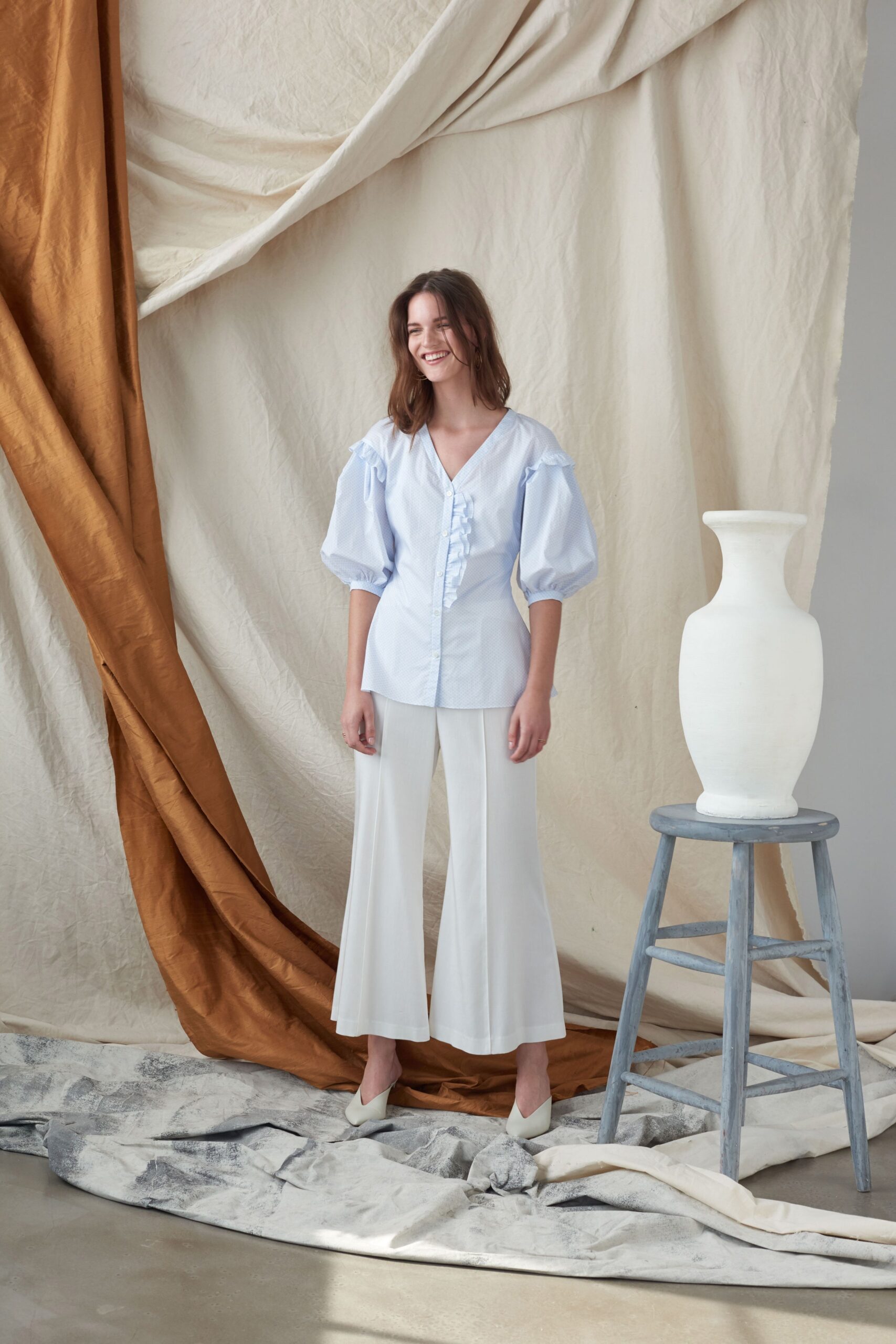 white relaxed shirt and flared pants