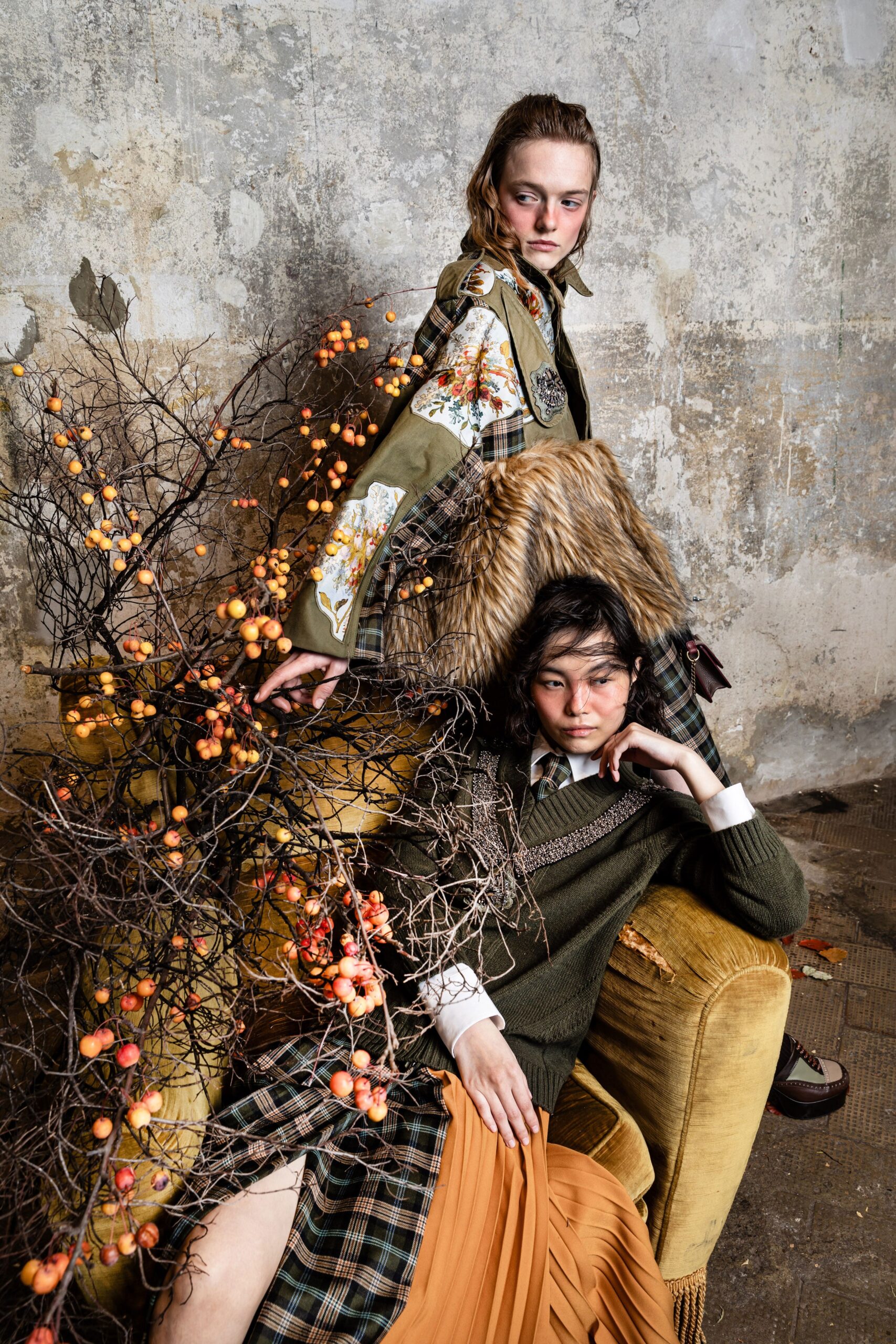 green coat and orange pleated dress