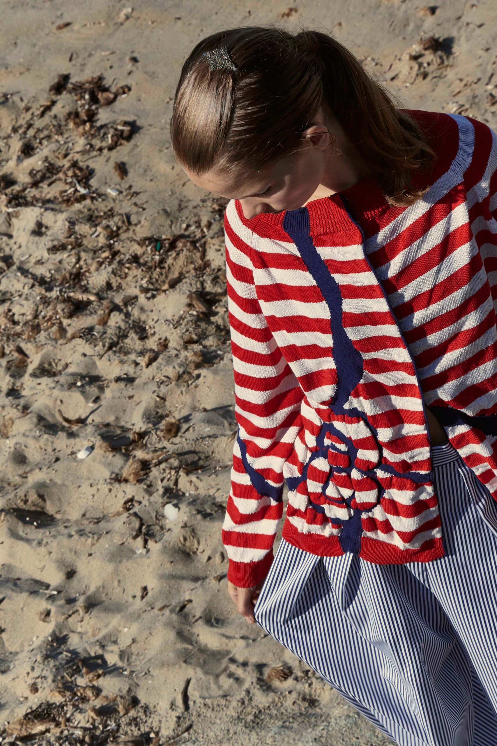 striped red and white sweater with blue pants