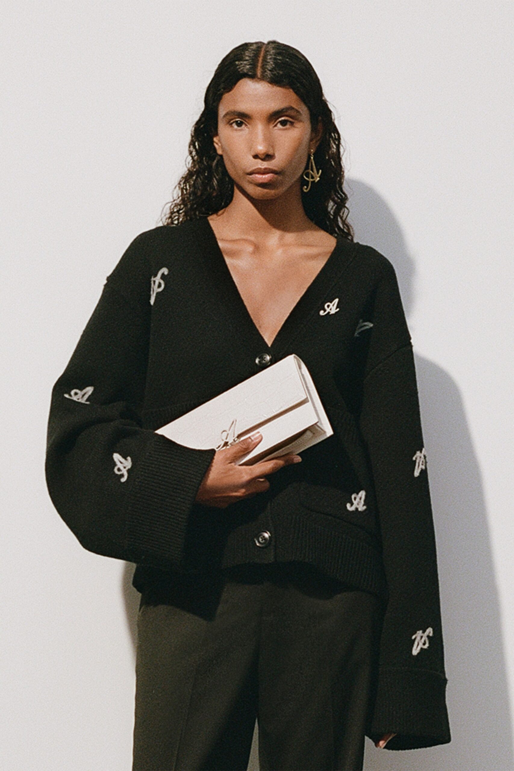 black oversized cardigan with clutch