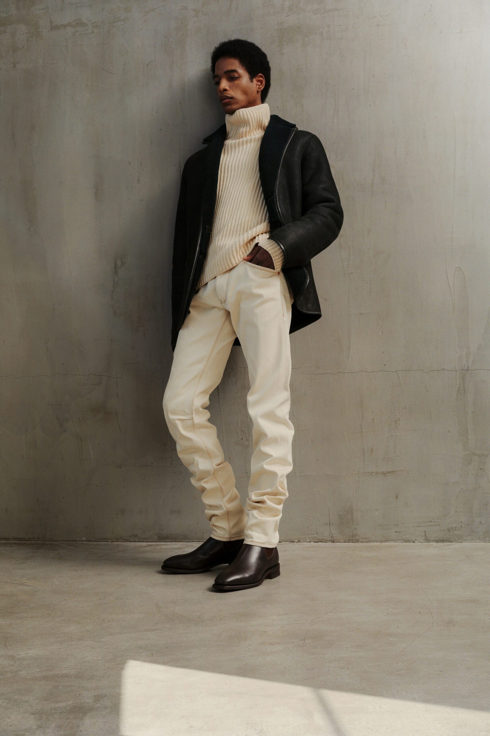 black leather coat with ivory sweater