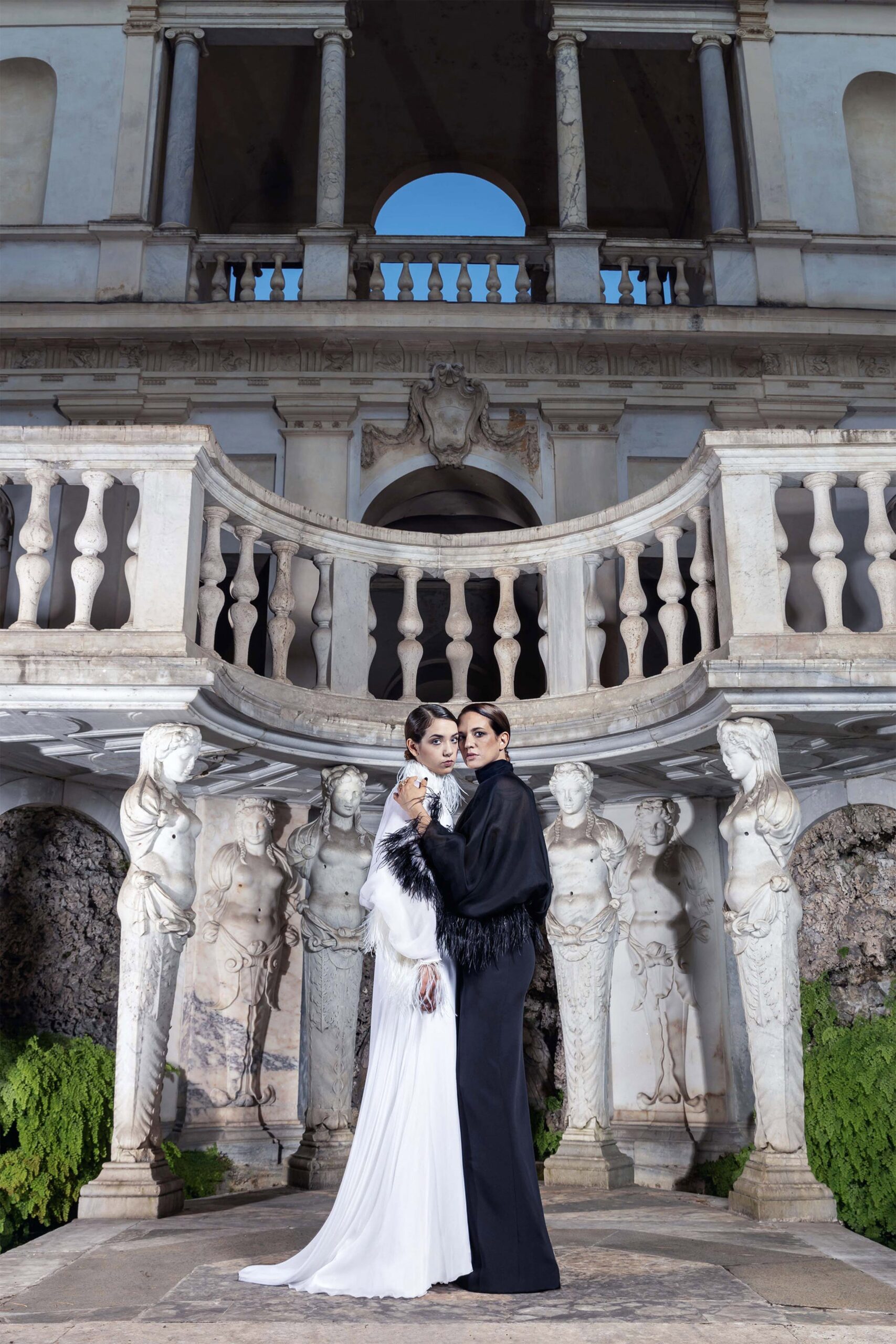 white silk gown and black coat