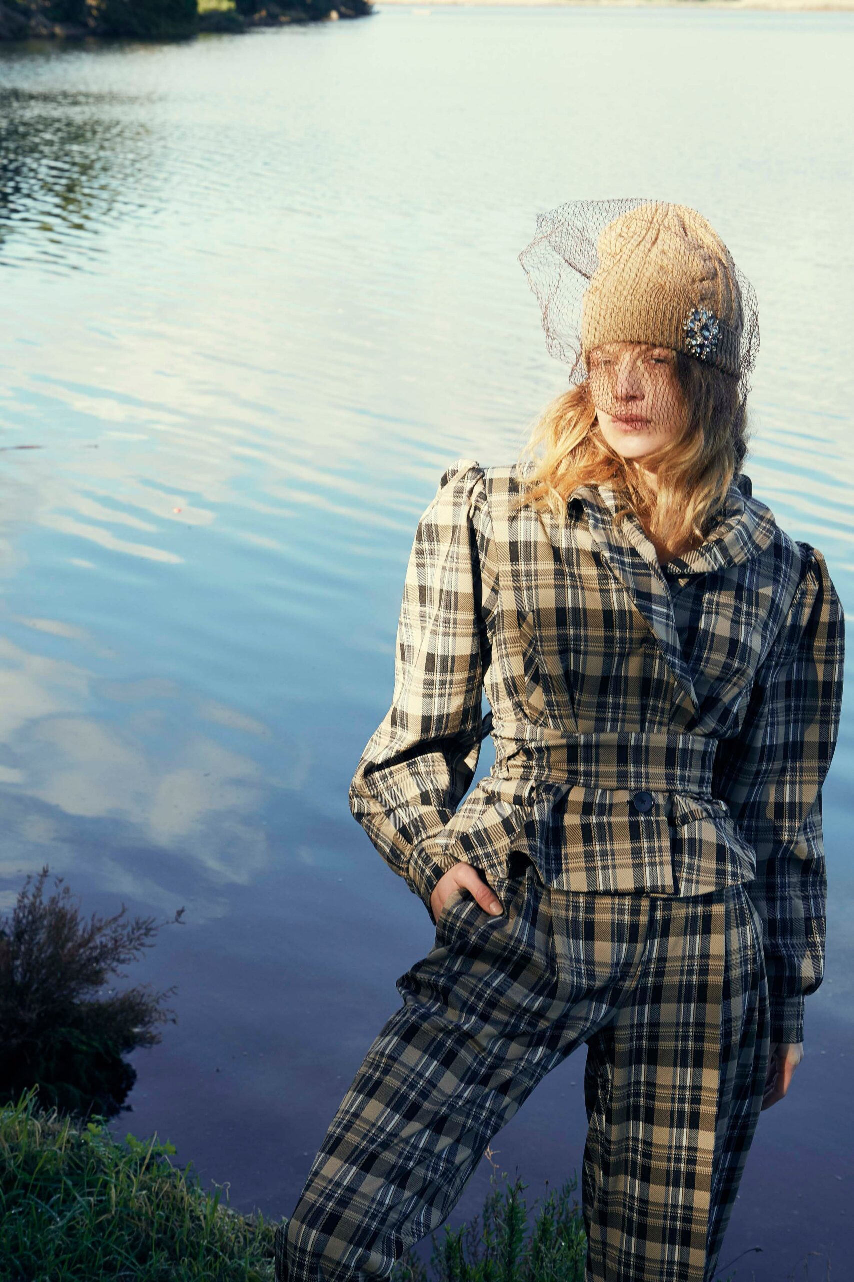 beige and black checked suit with knit hat