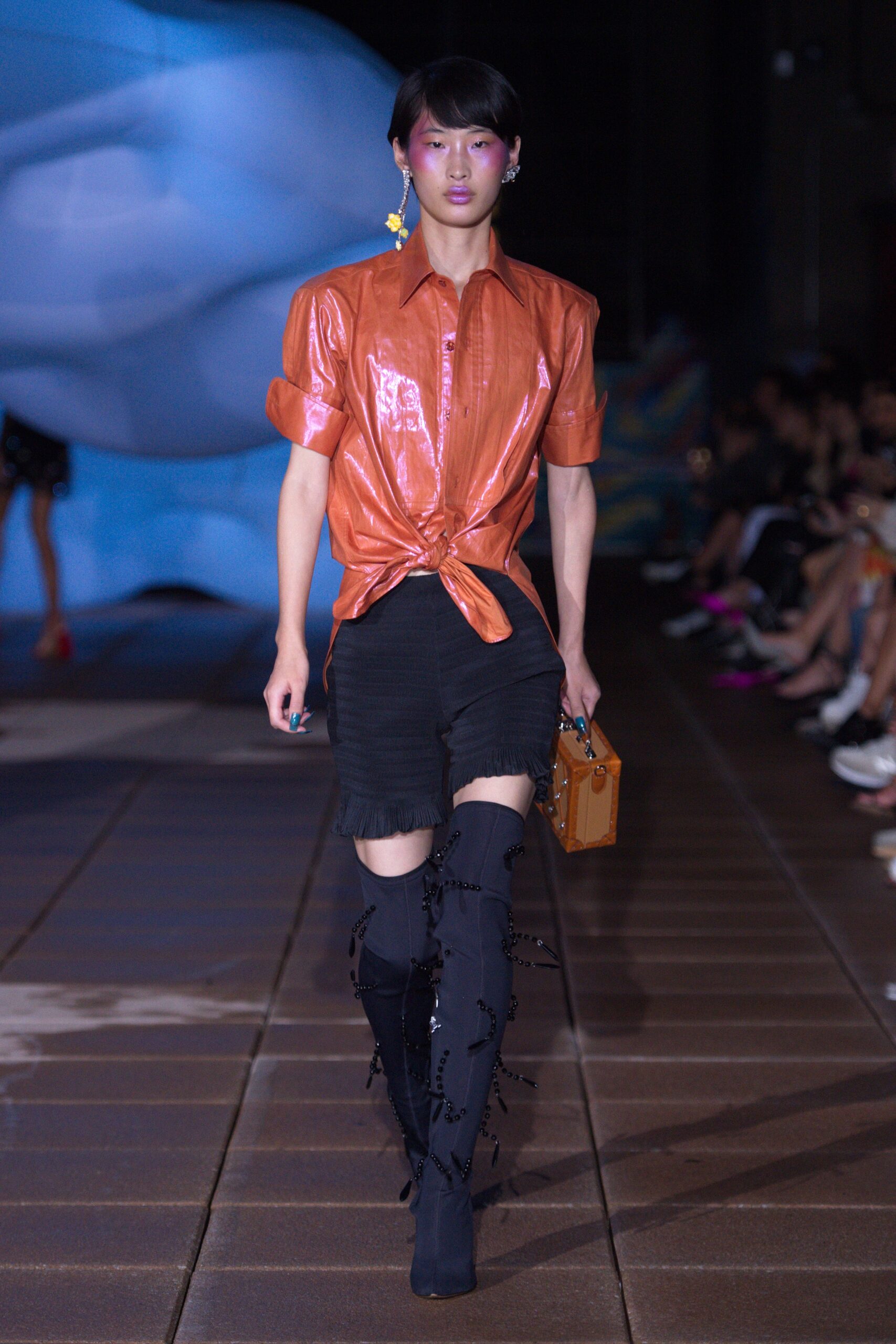 fitted orange silk shirt and black denim shorts