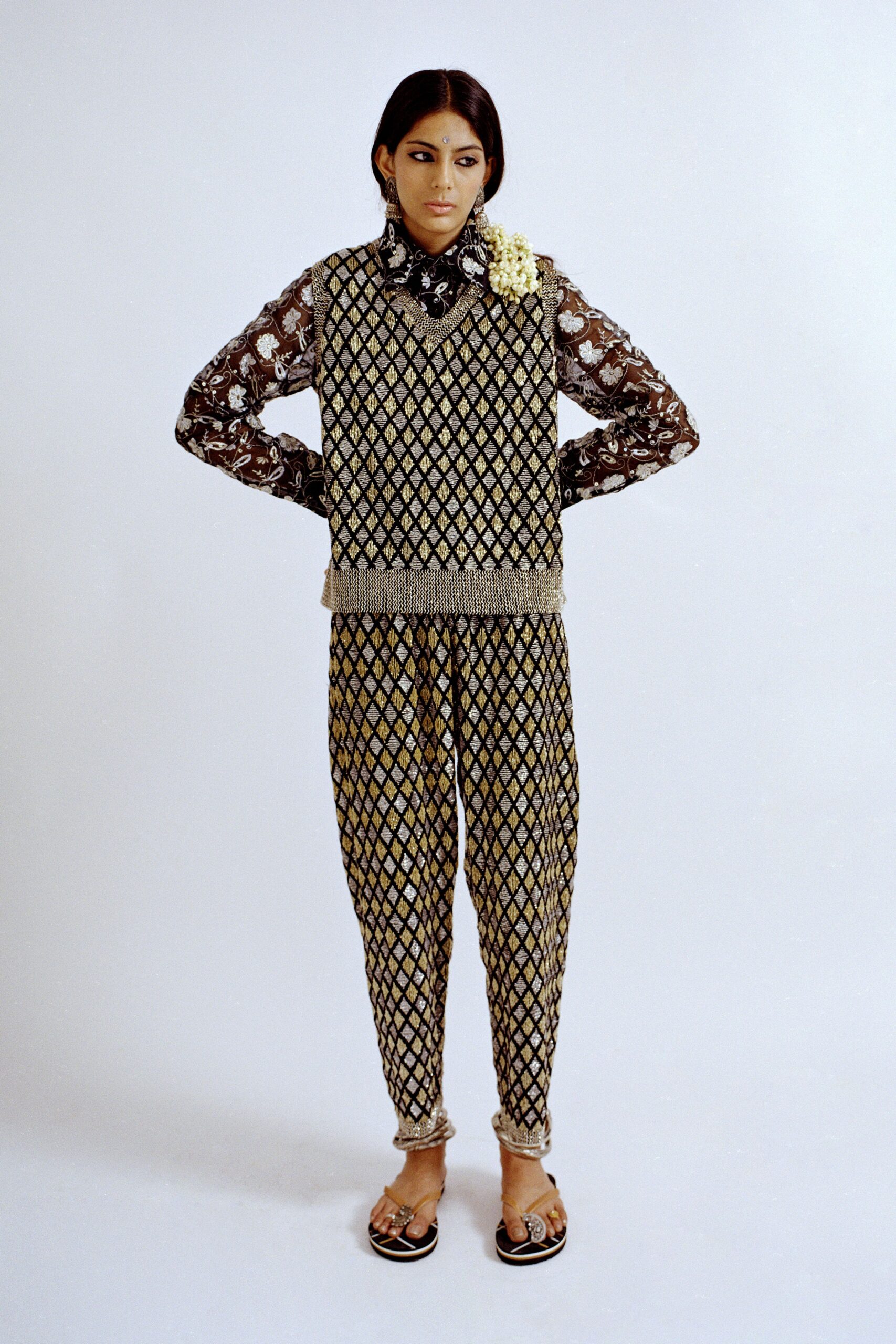 black lace top with gold pants