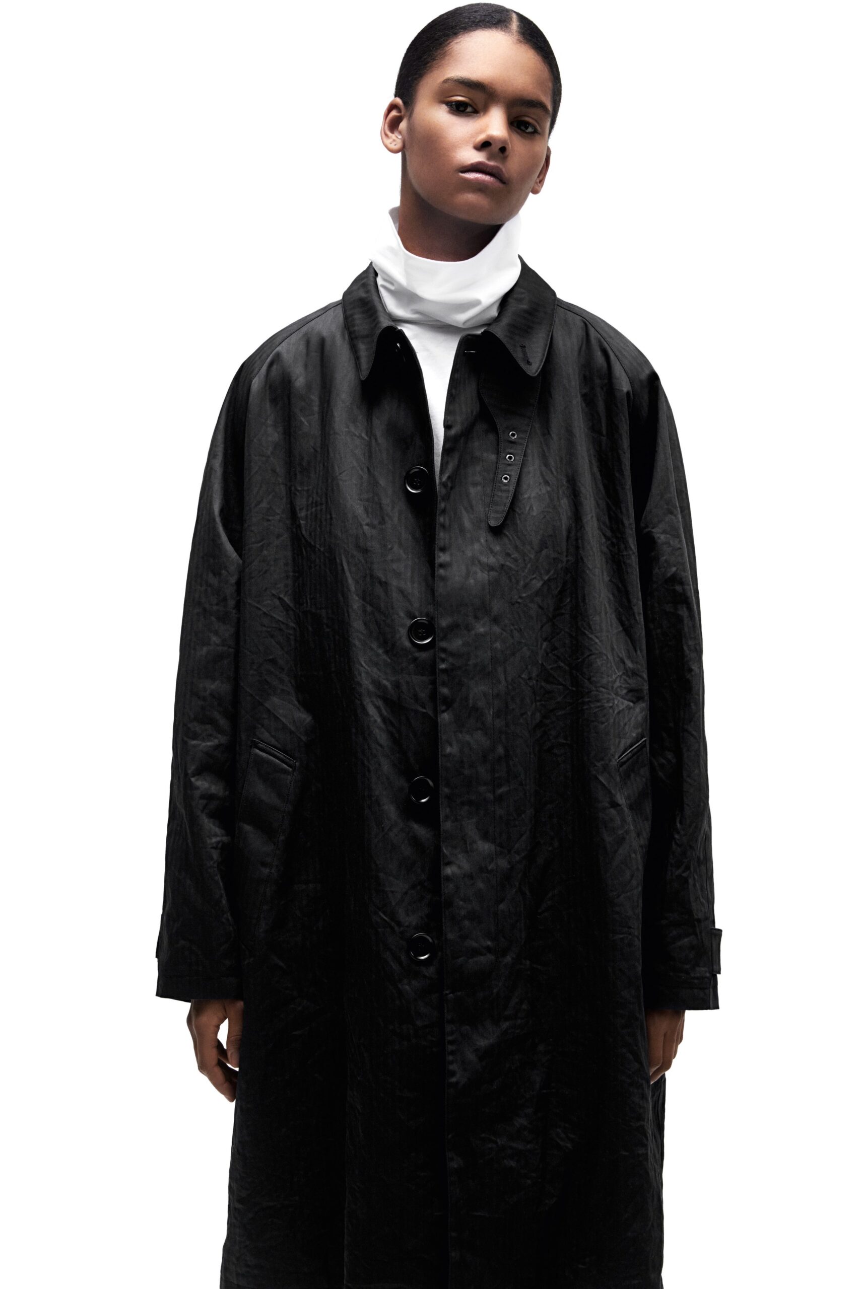 black oversized coat and white turtleneck
