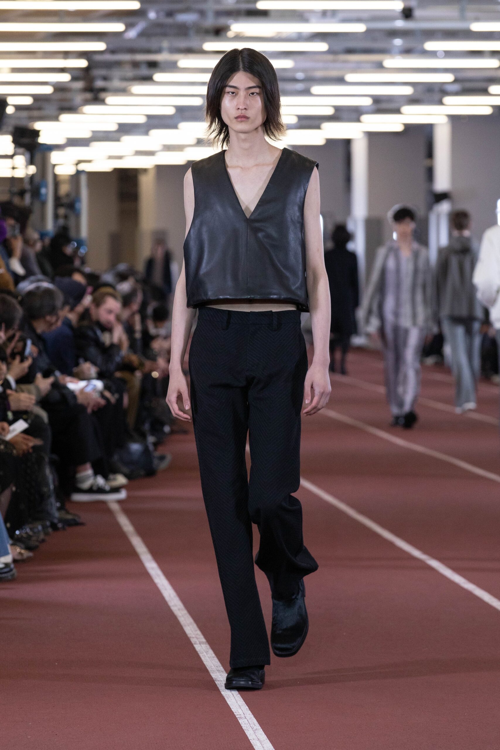 black leather sleeveless top and slim pants