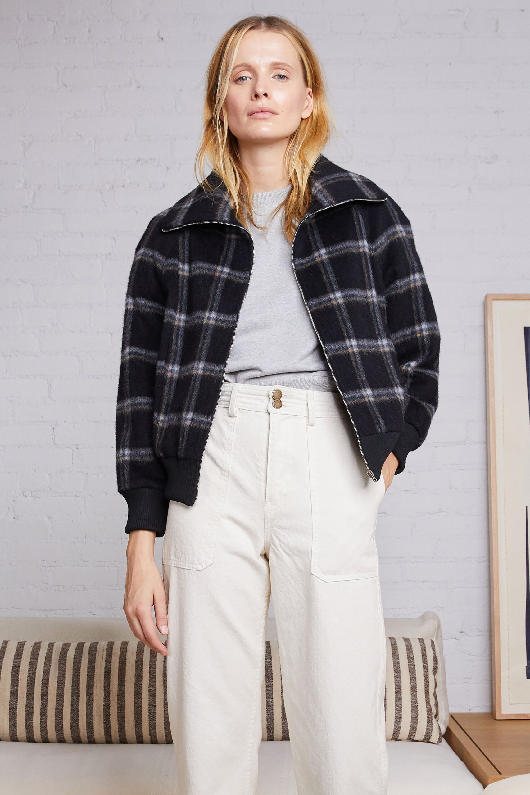 checked jacket with gray top and white pants