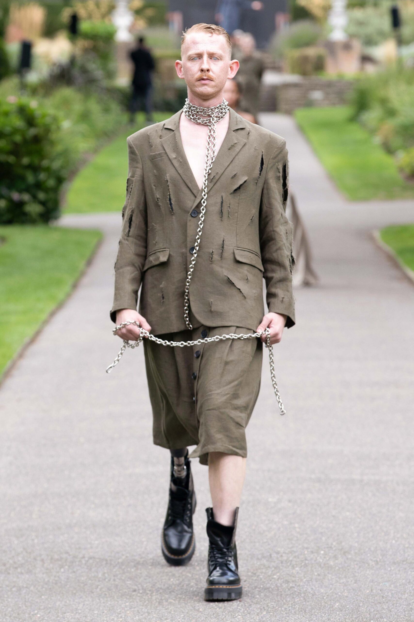 green distressed suit with boots