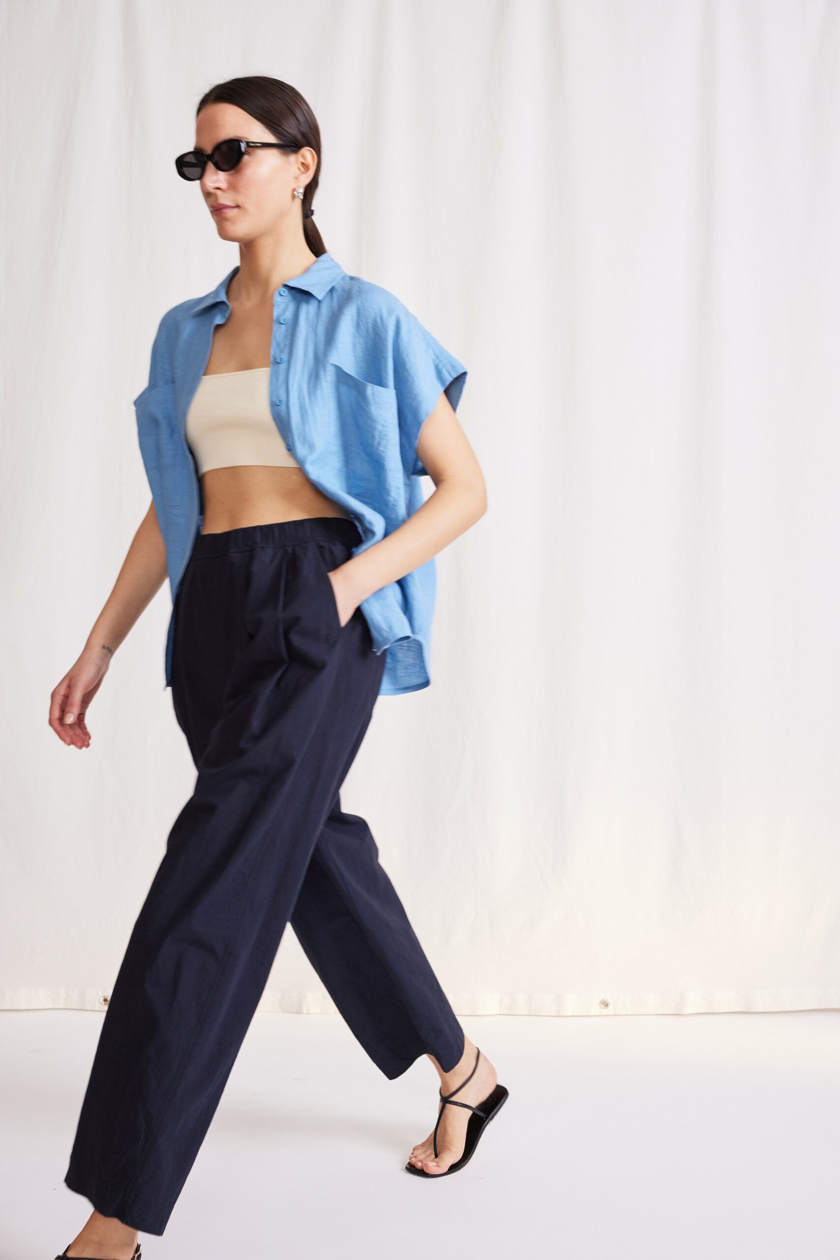 blue shirt beige top black pants