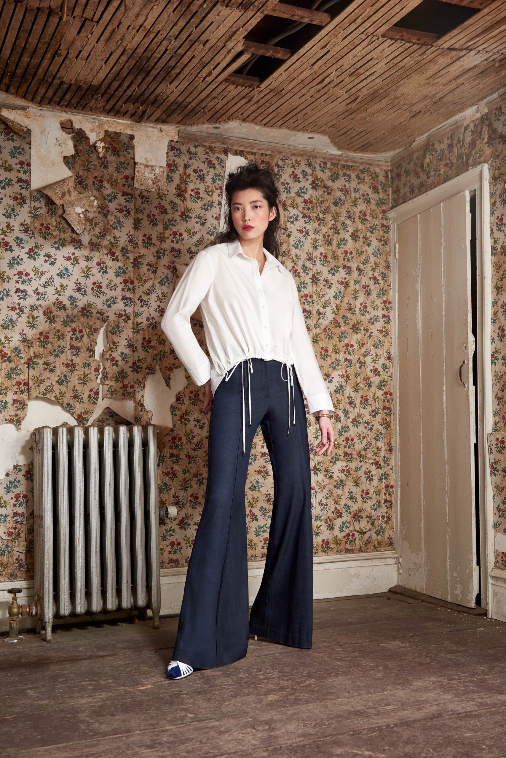 white relaxed shirt and blue flared pants