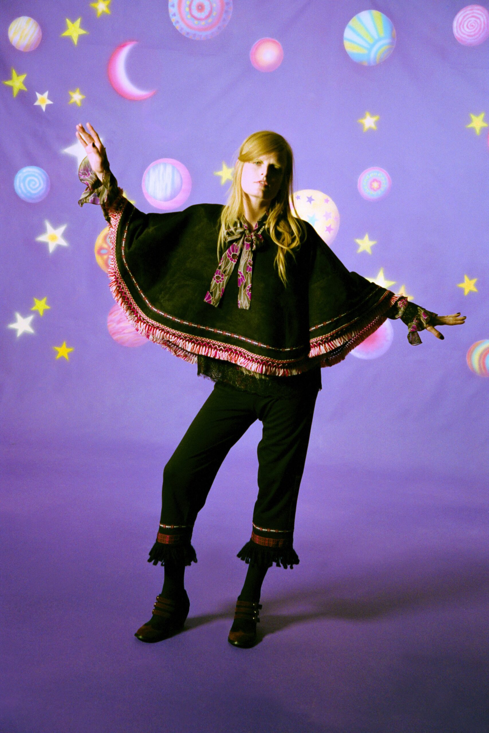 black wool poncho and fitted pants