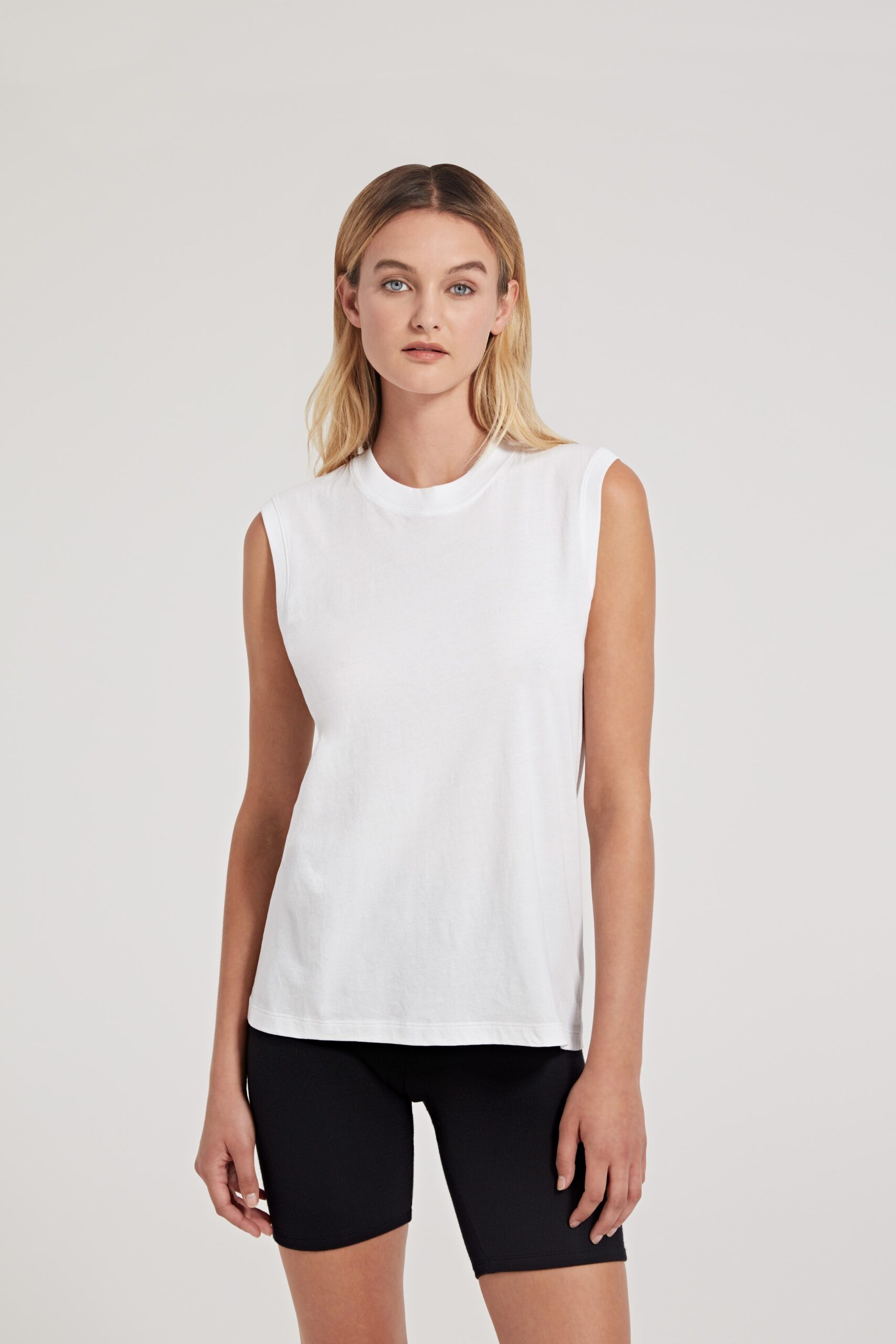 white sleeveless top with black shorts