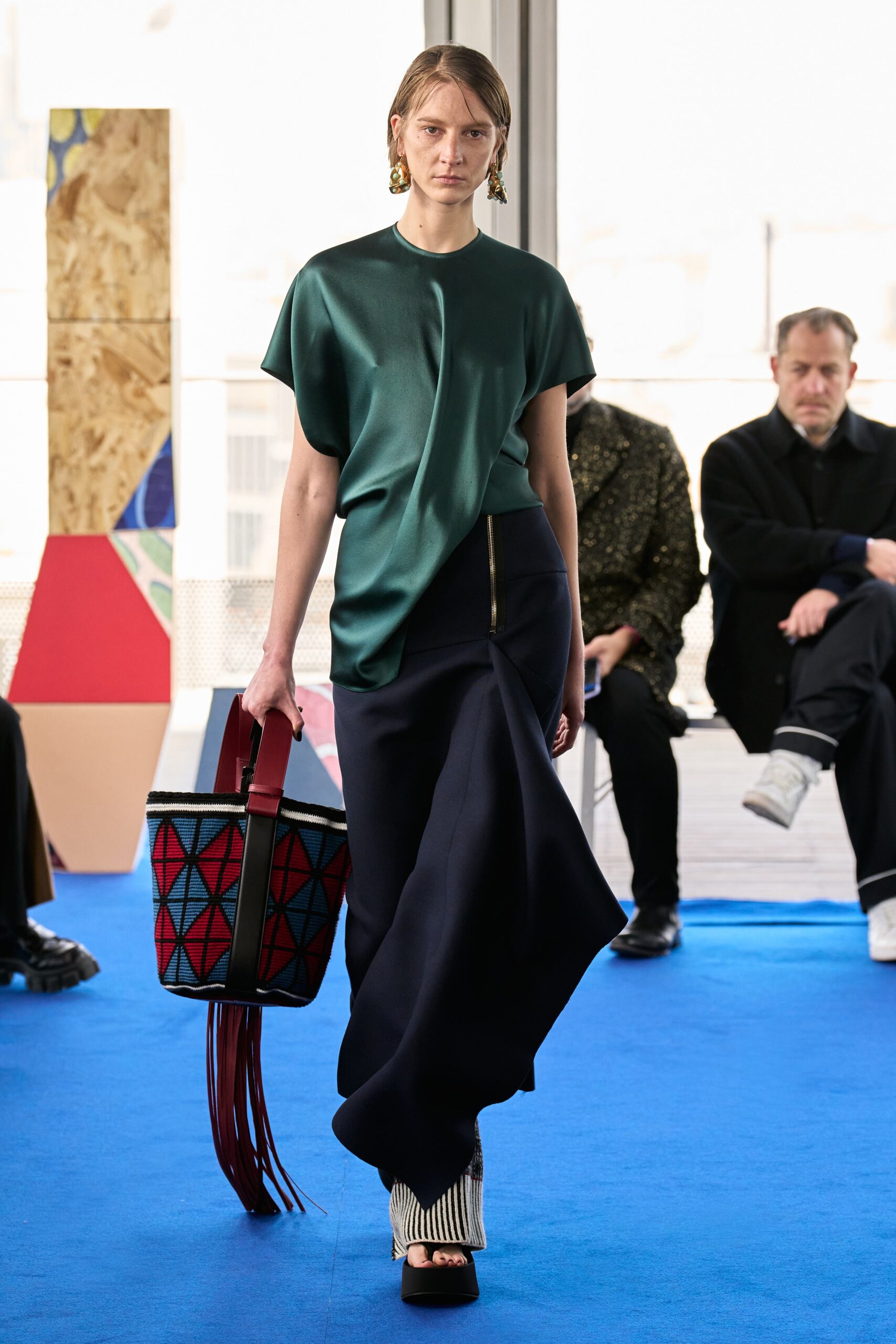 green silk relaxed top with navy skirt