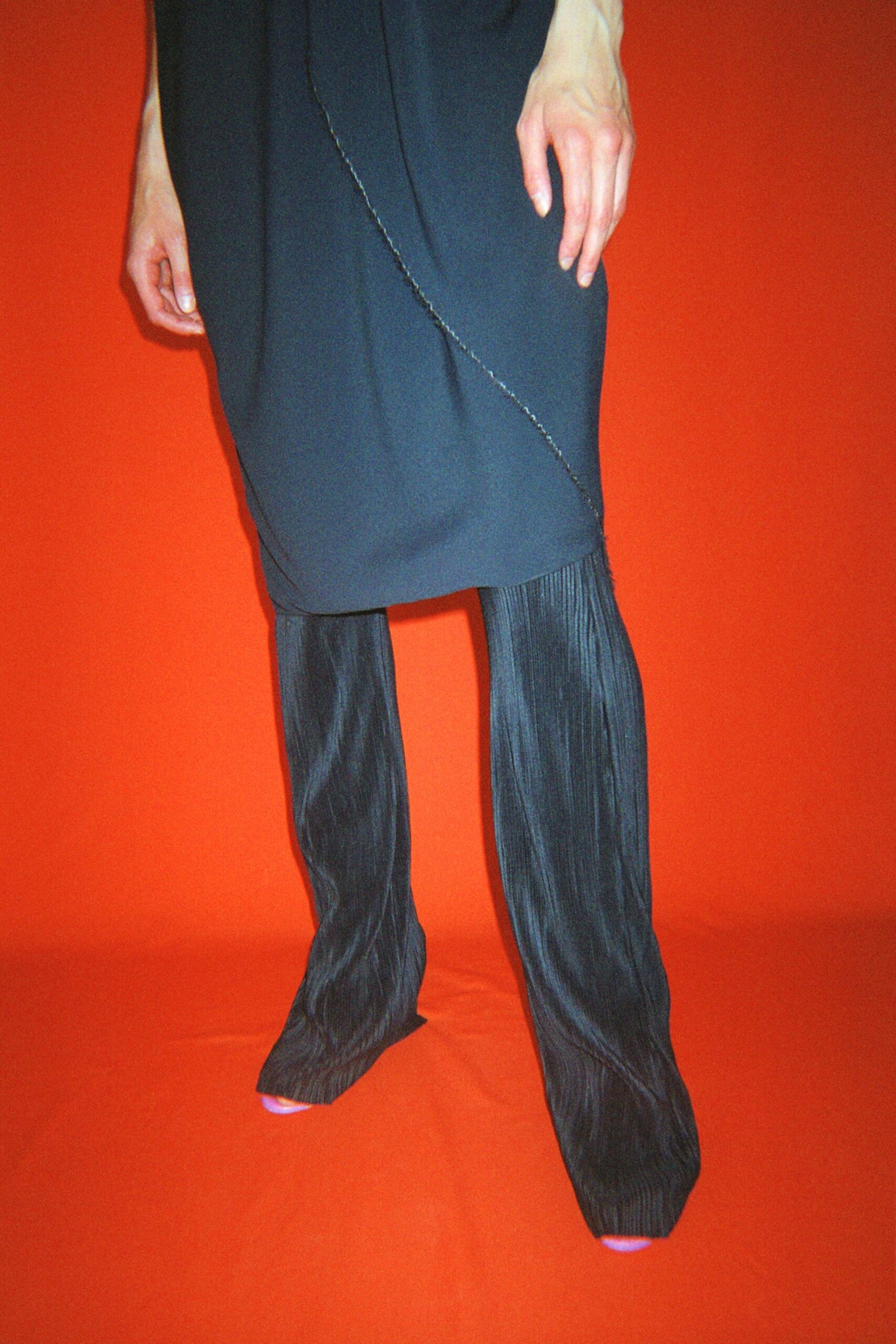 black silk sleeveless dress and pleated pants