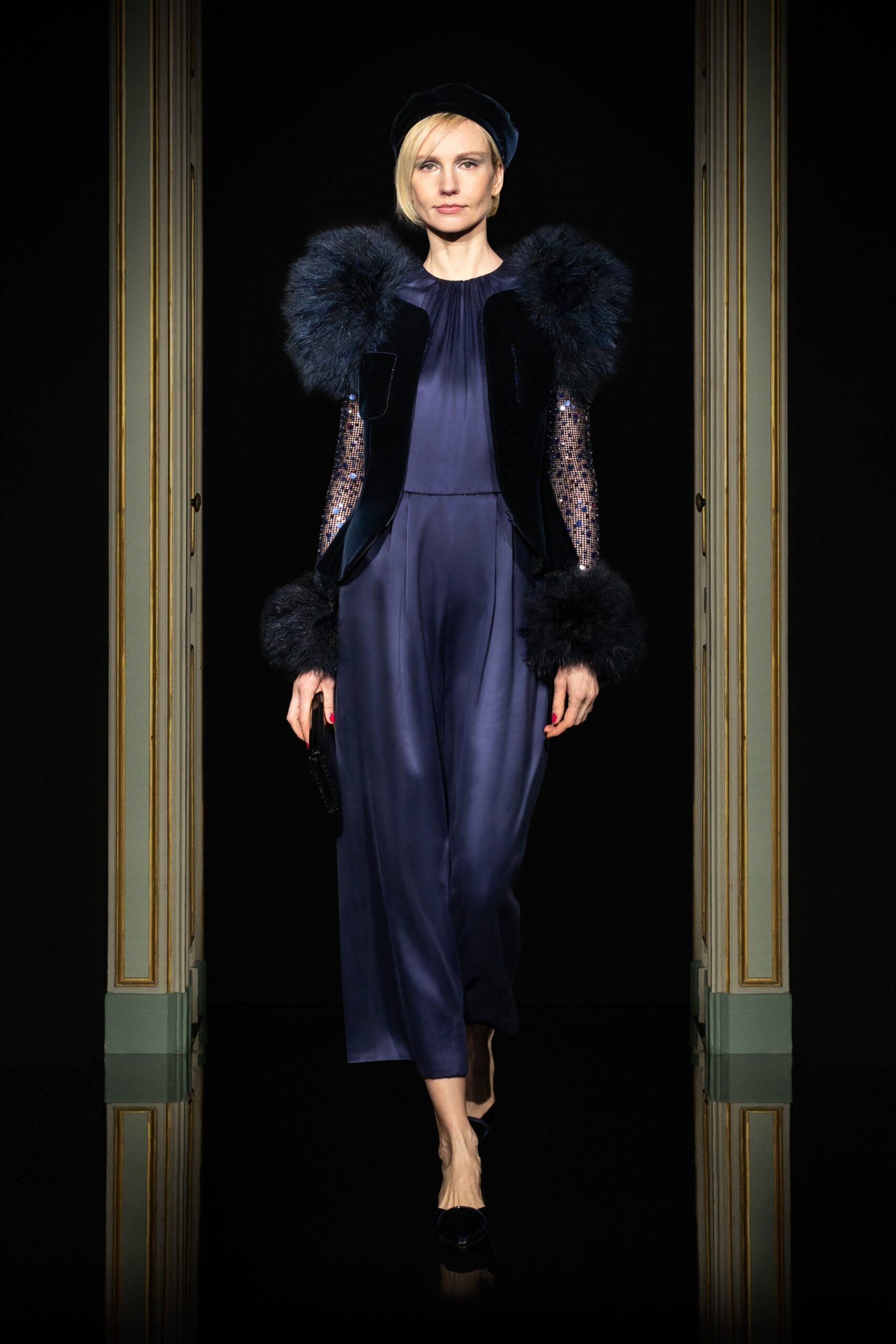 blue silk fitted jumpsuit with black fur cape