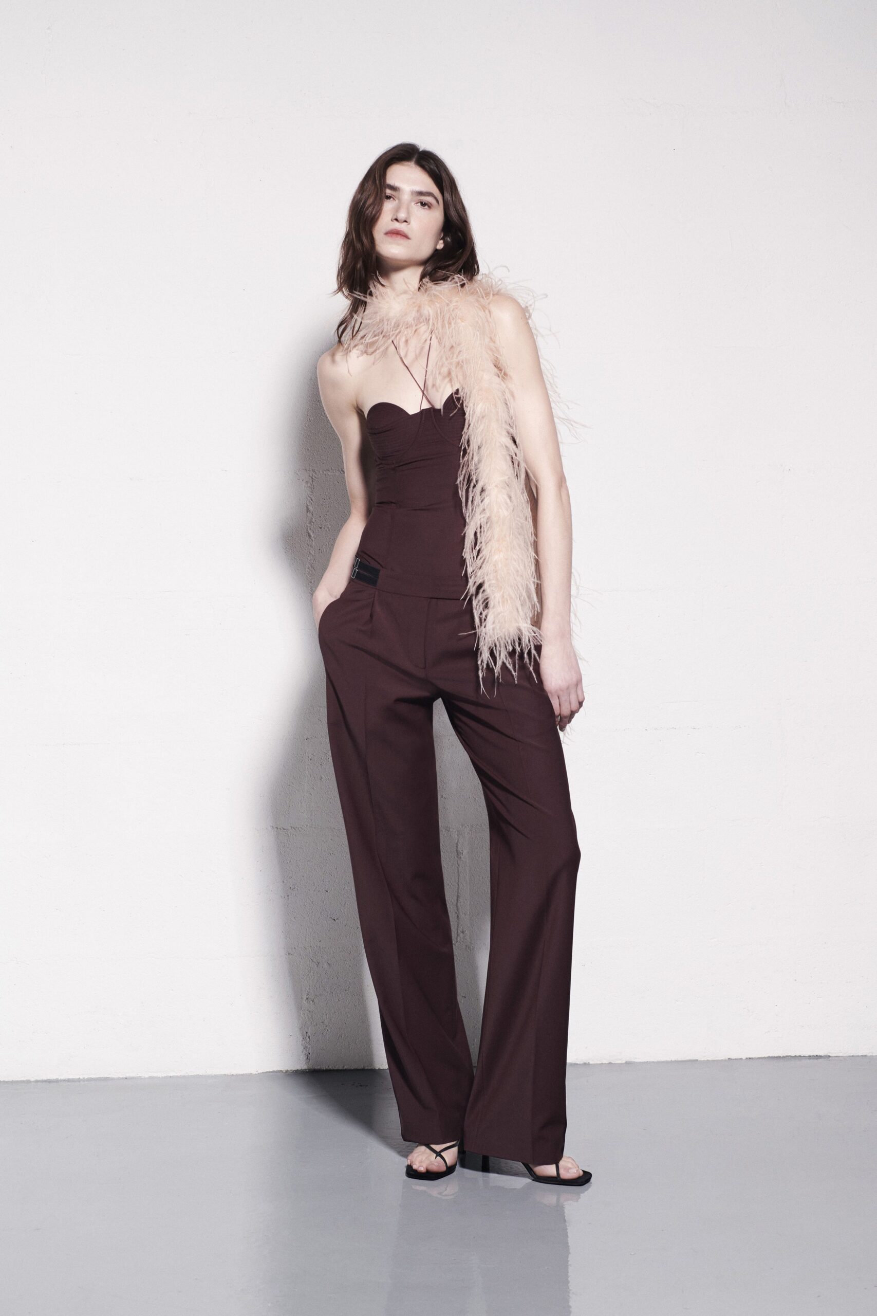 maroon fitted jumpsuit with feather scarf
