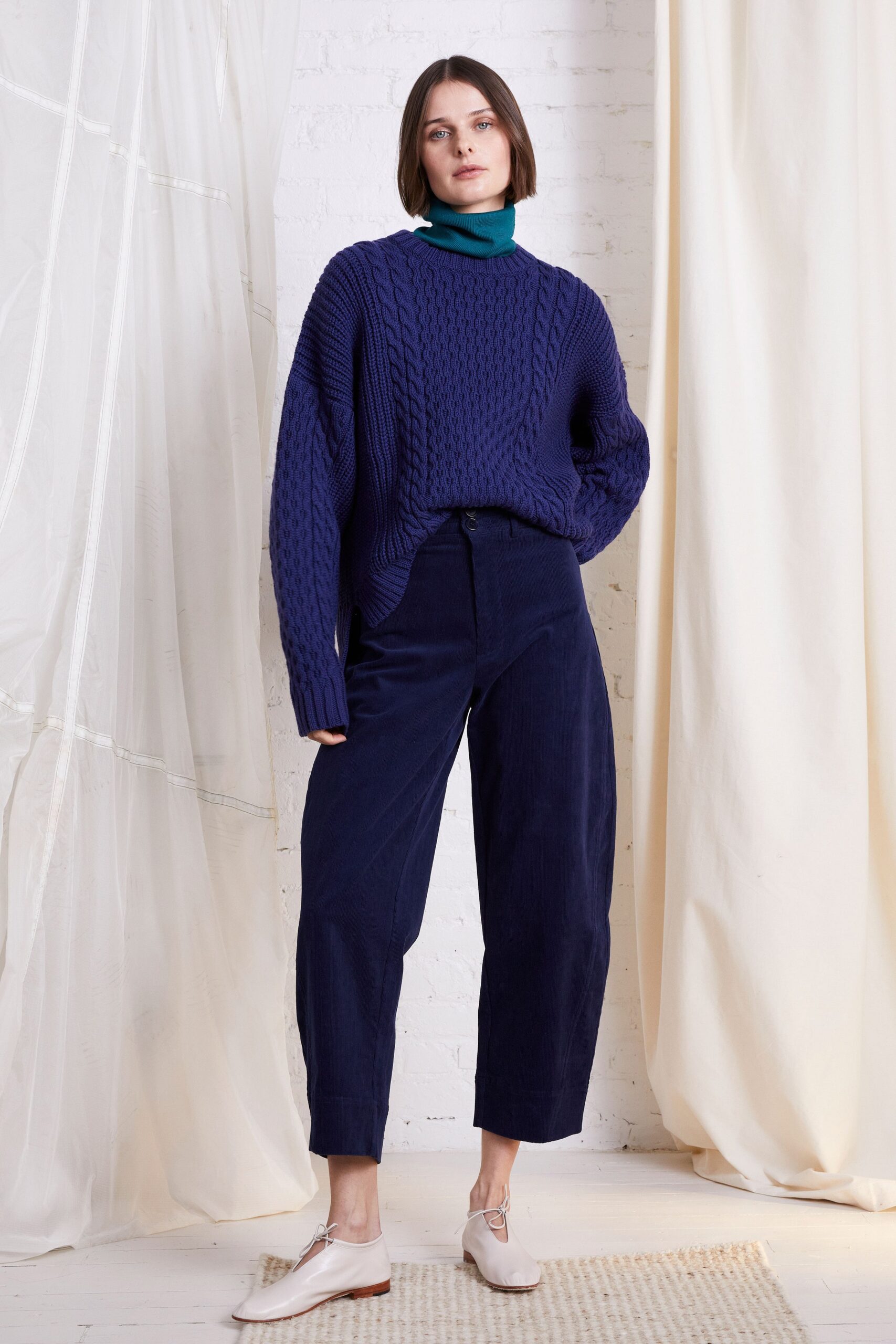 oversized blue knitted sweater and relaxed navy pants