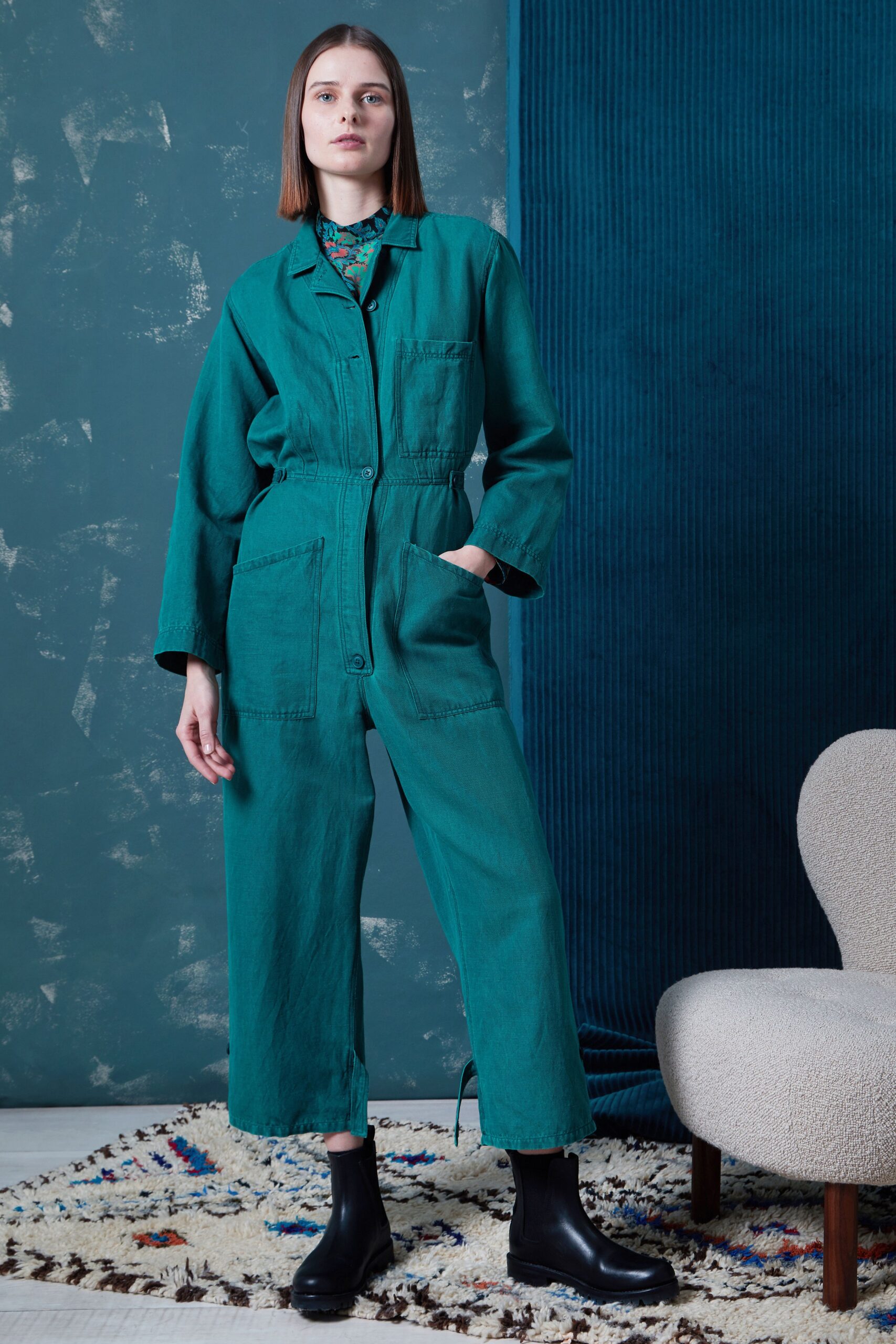 teal relaxed jumpsuit with black boots