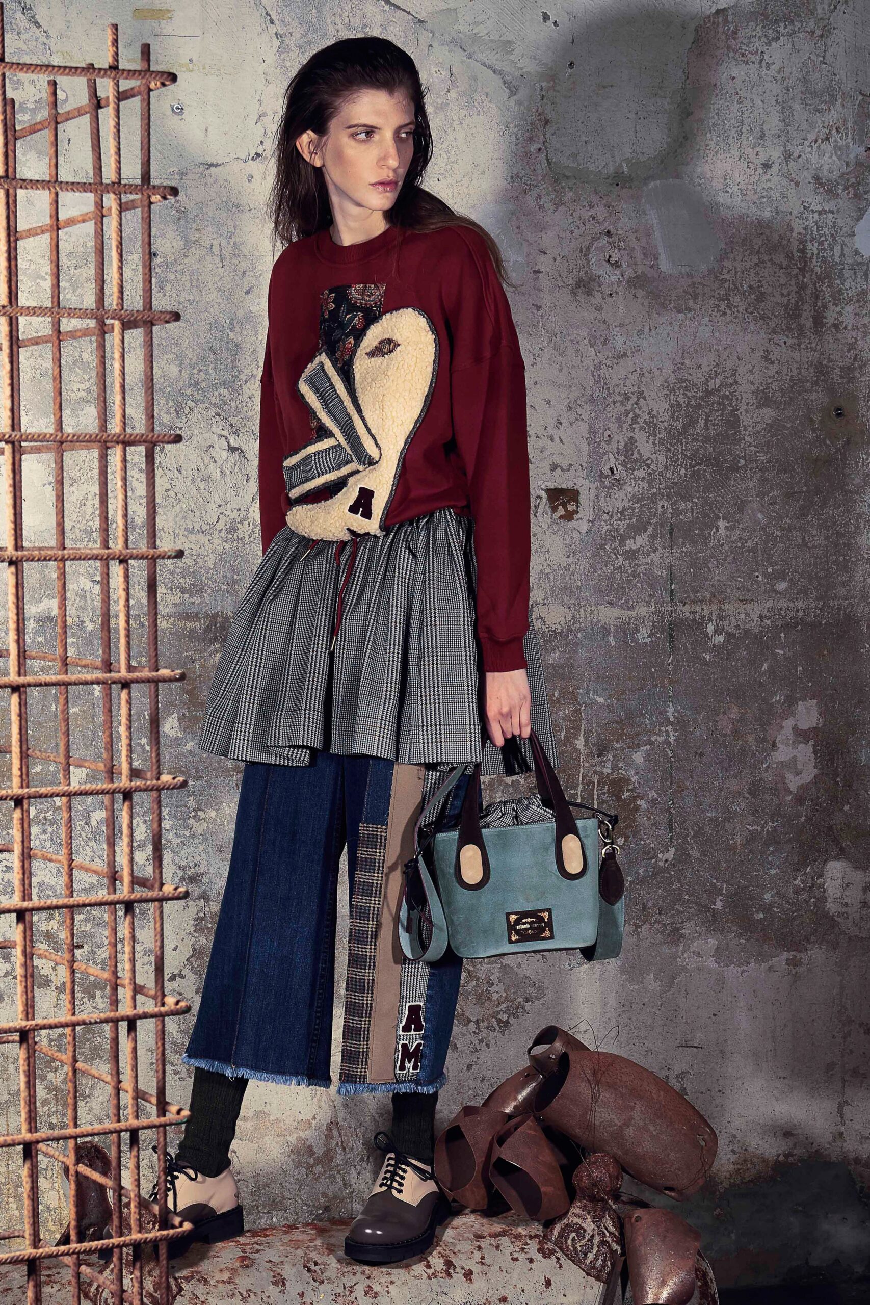 red embroidered sweater with gray pleated skirt
