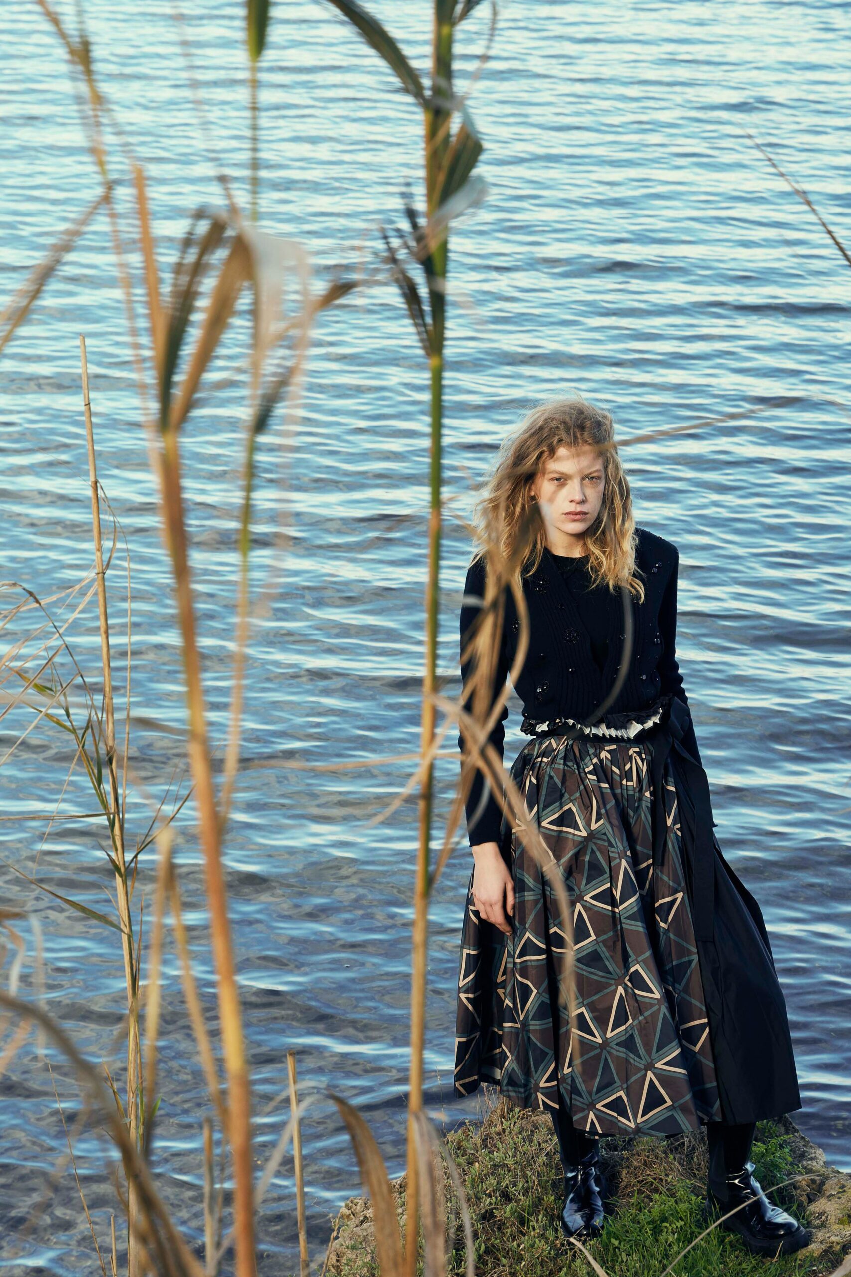 black fitted top with multi pleated skirt
