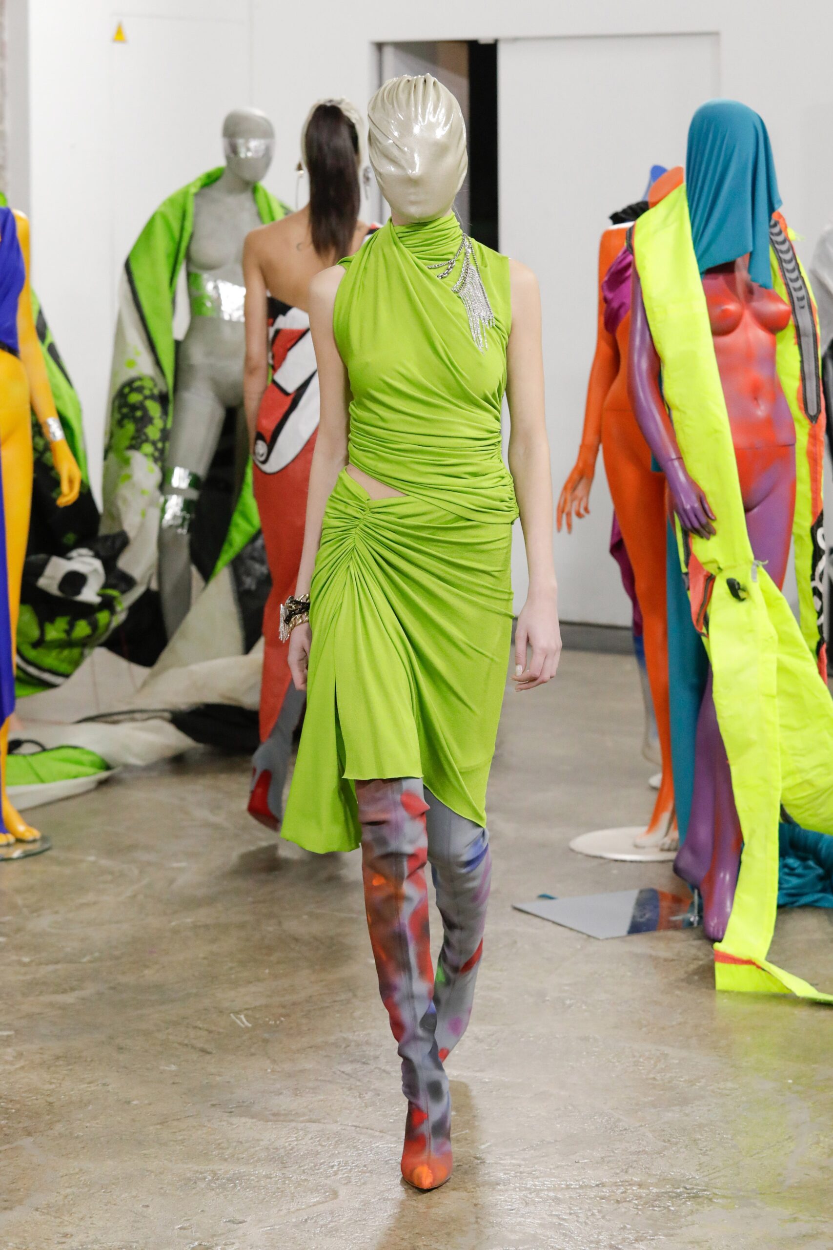 fitted green midi dress with multi-colored boots