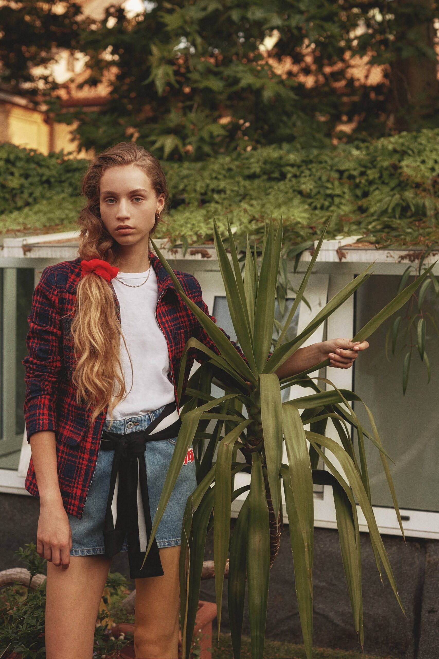 red checked blazer with white t-shirt and denim shorts