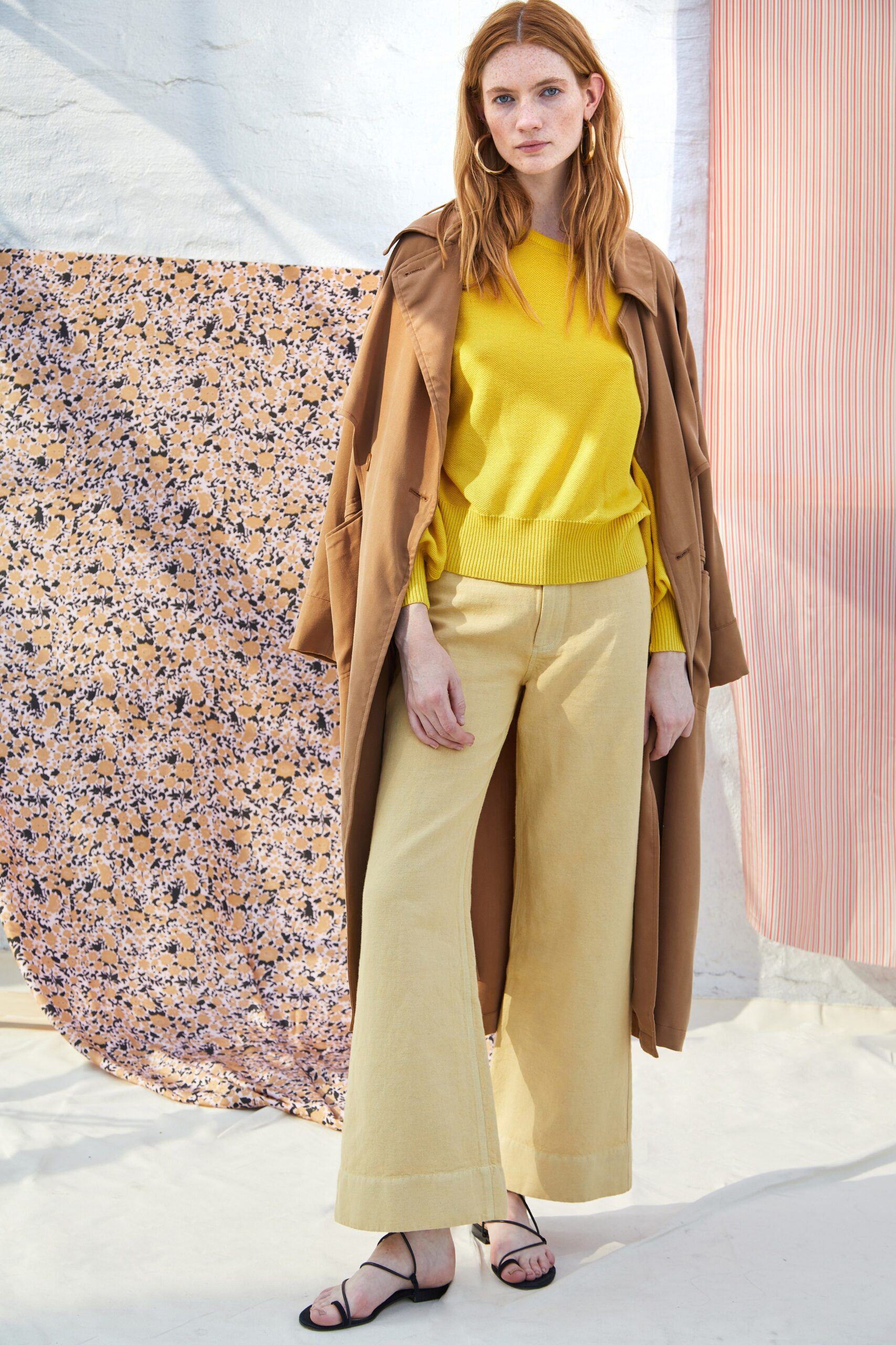 brown coat yellow sweater beige pants