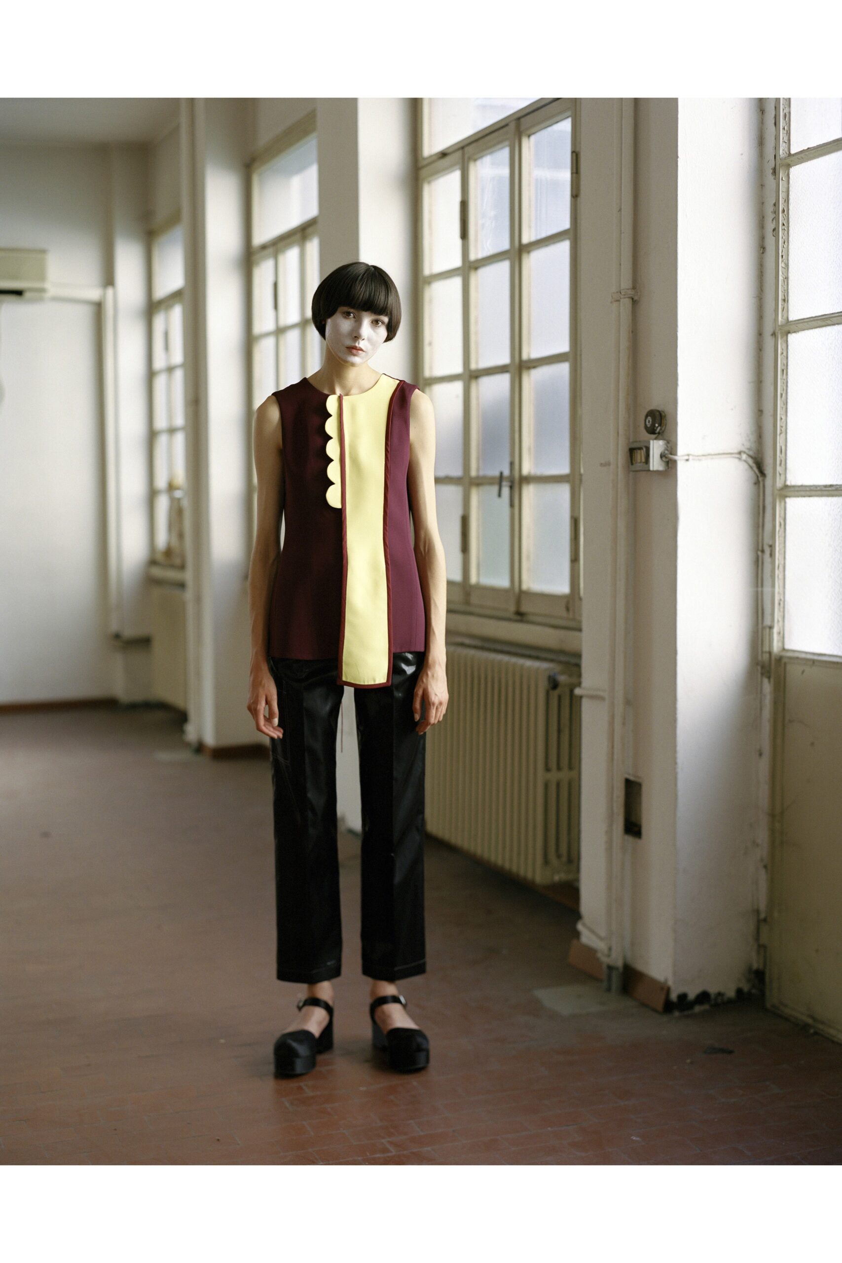 fitted maroon top and tailored black pants
