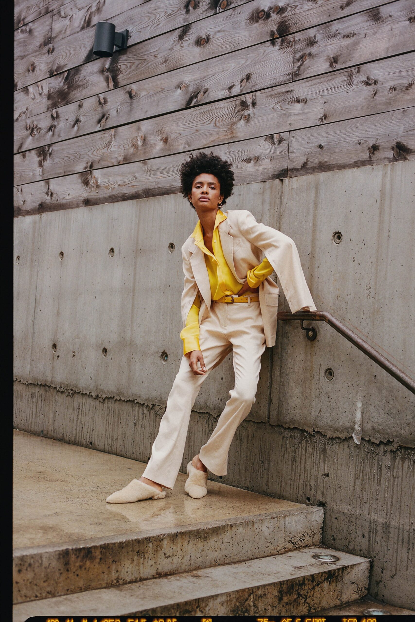 beige tailored suit with yellow shirt