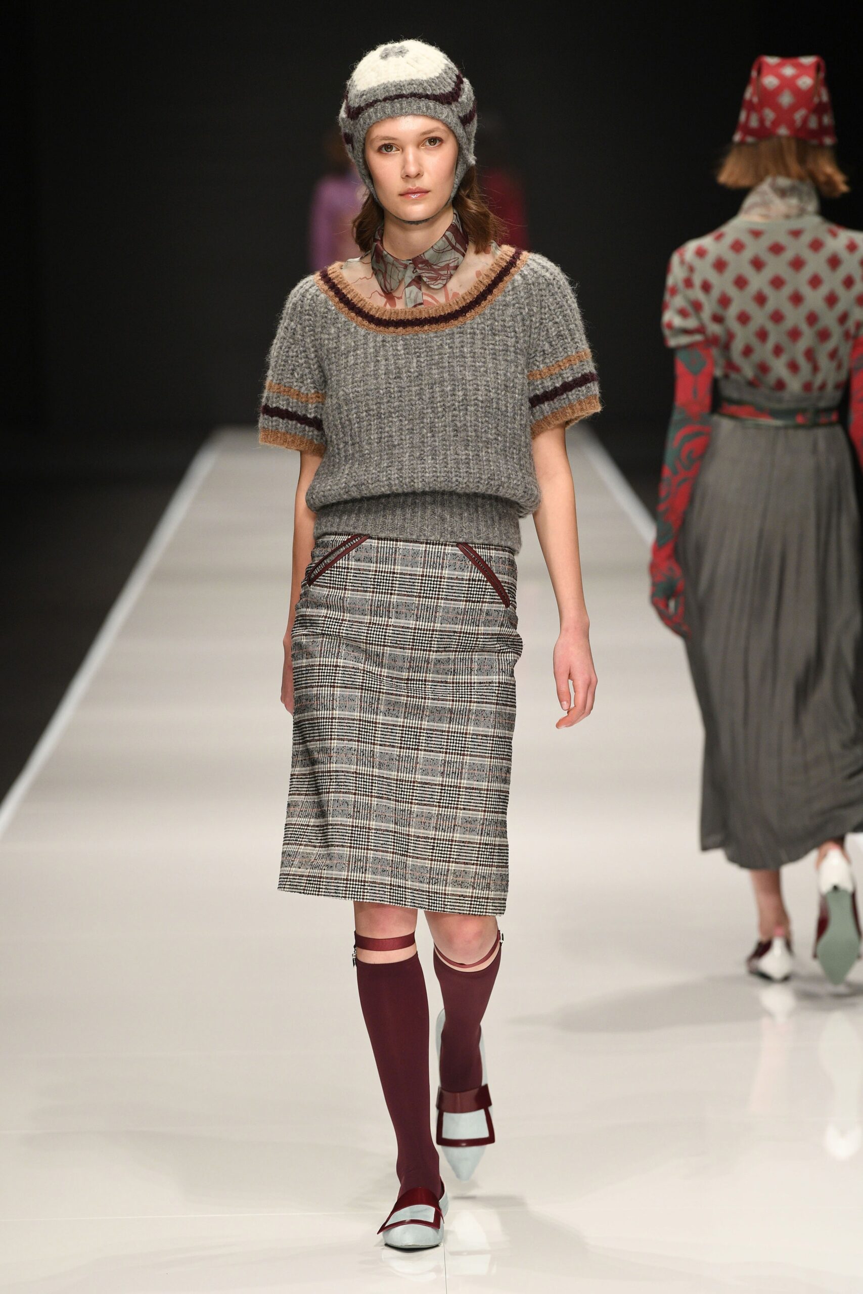 gray fitted top with plaid skirt