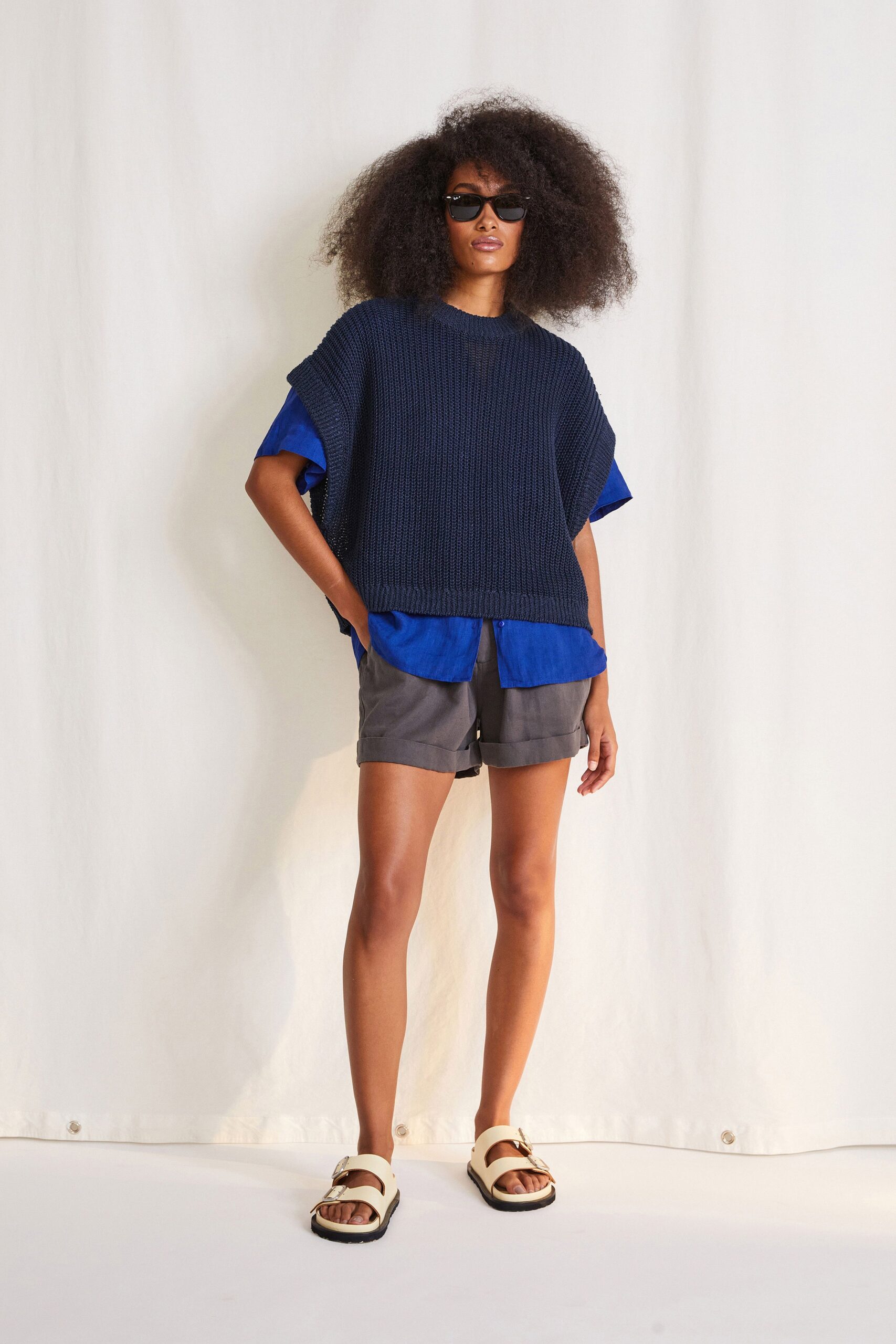 navy top with blue shirt and gray shorts