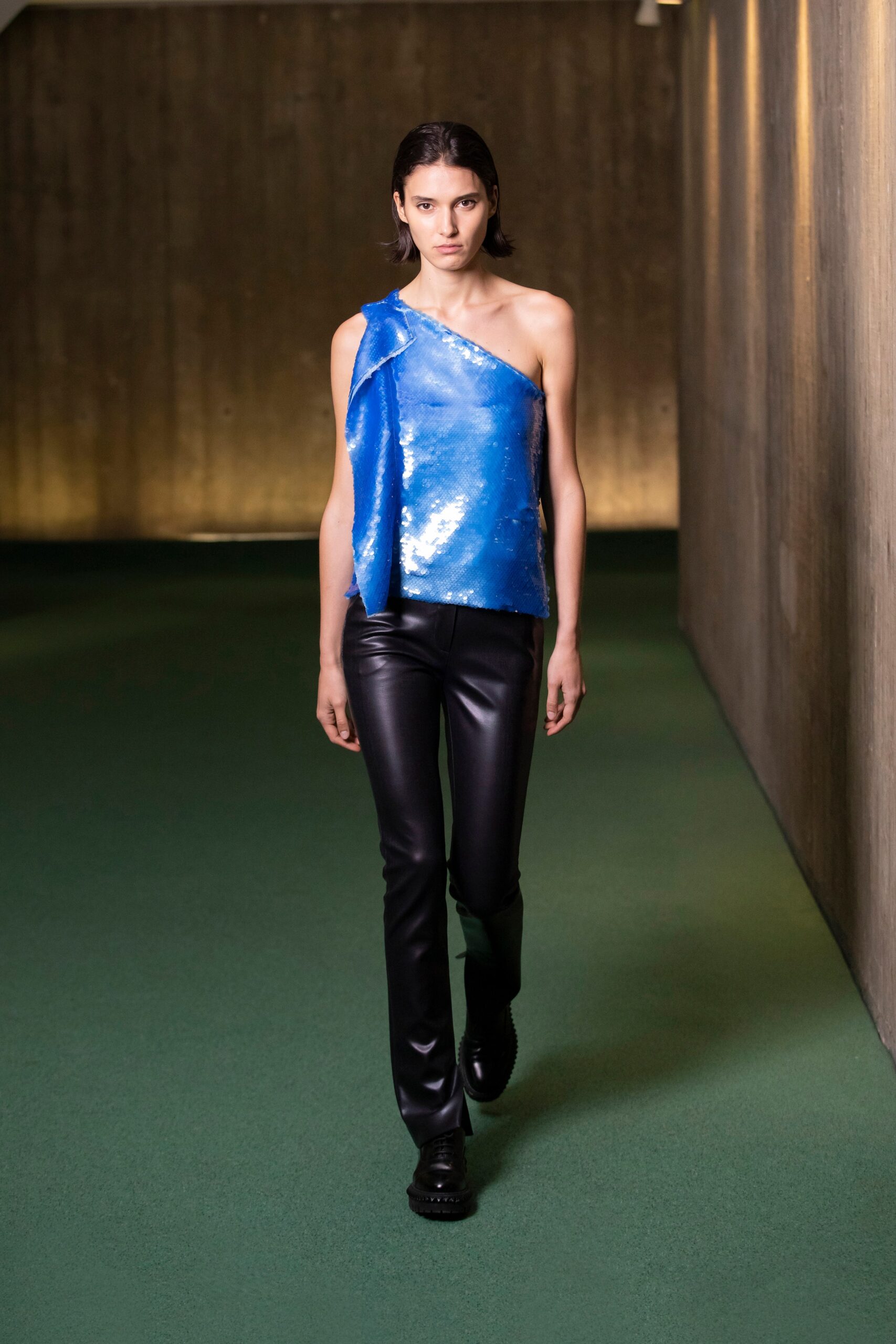 blue asymmetric top with black pants