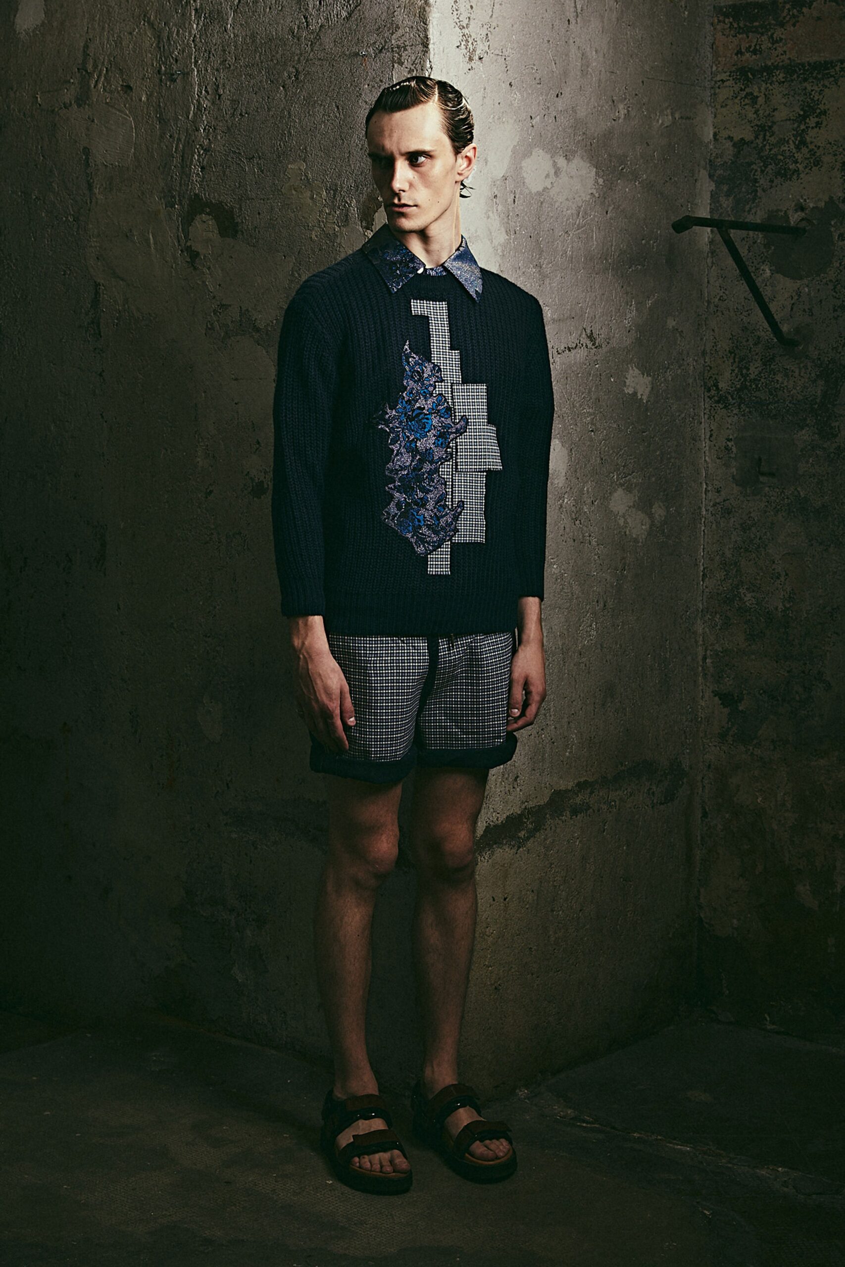 blue relaxed sweater with checkered shorts