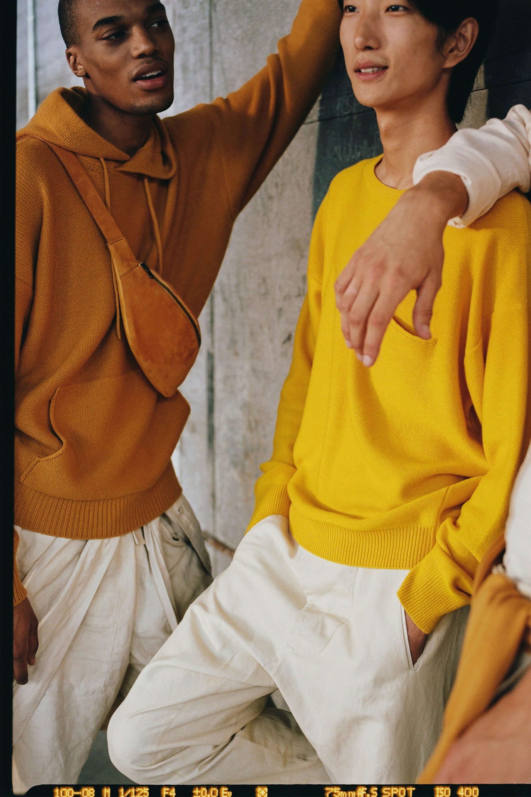 yellow relaxed sweater with white pants