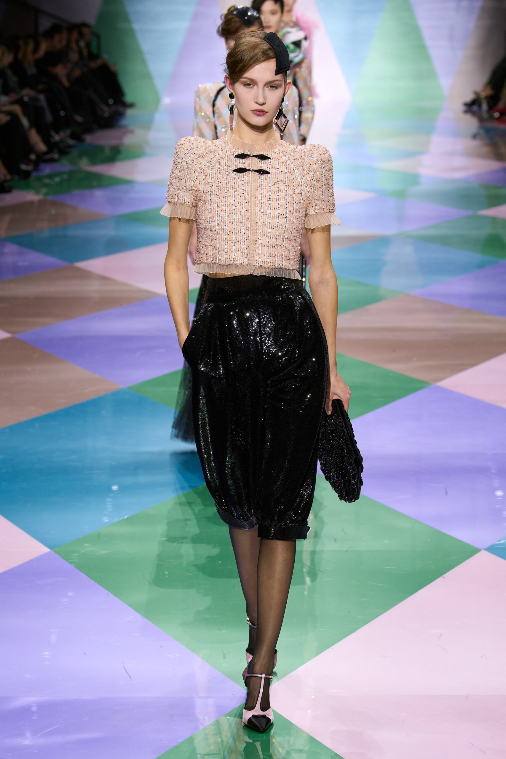 pink silk fitted top and black pants