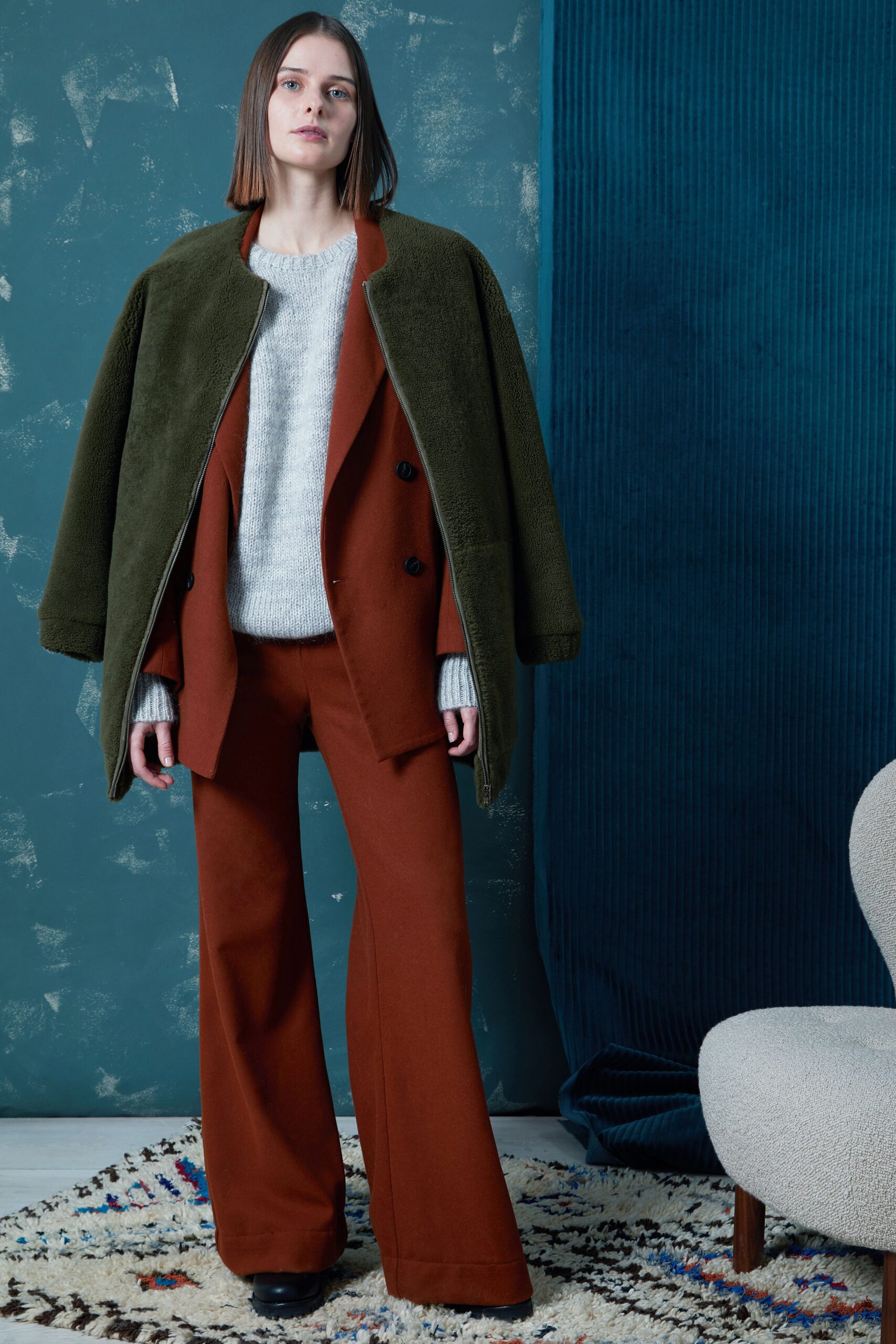 green coat red blazer gray sweater brown flared pants