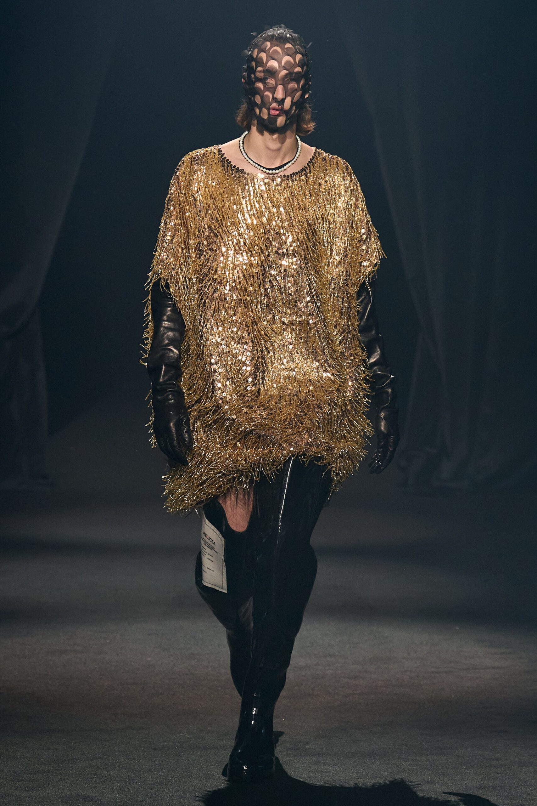 gold fringed top with black pants