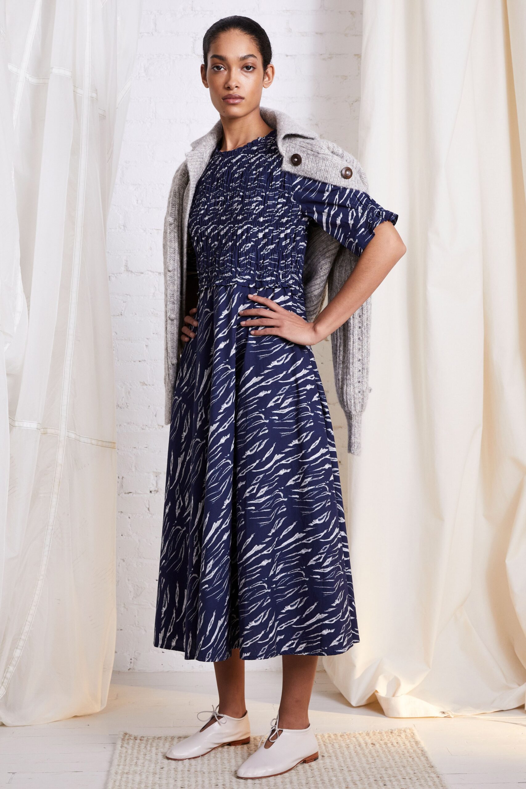 blue and white printed midi dress with gray cardigan