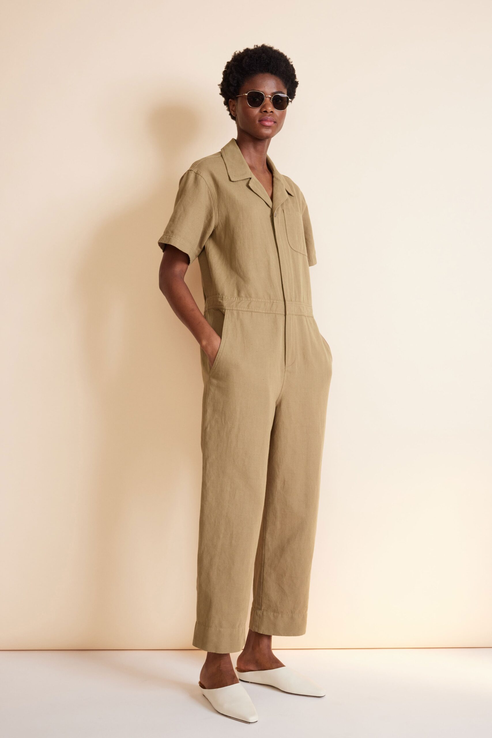 beige relaxed jumpsuit with sunglasses