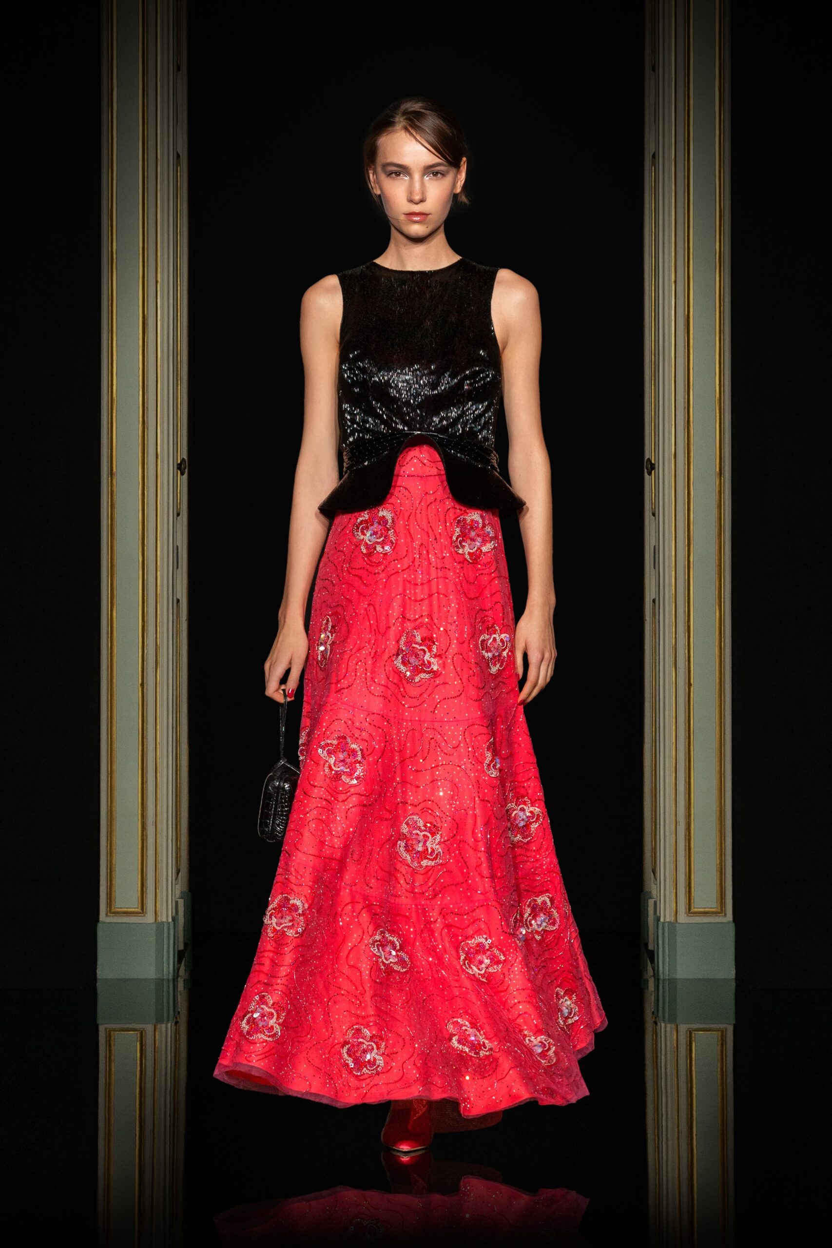 black silk sleeveless top and red embroidered skirt