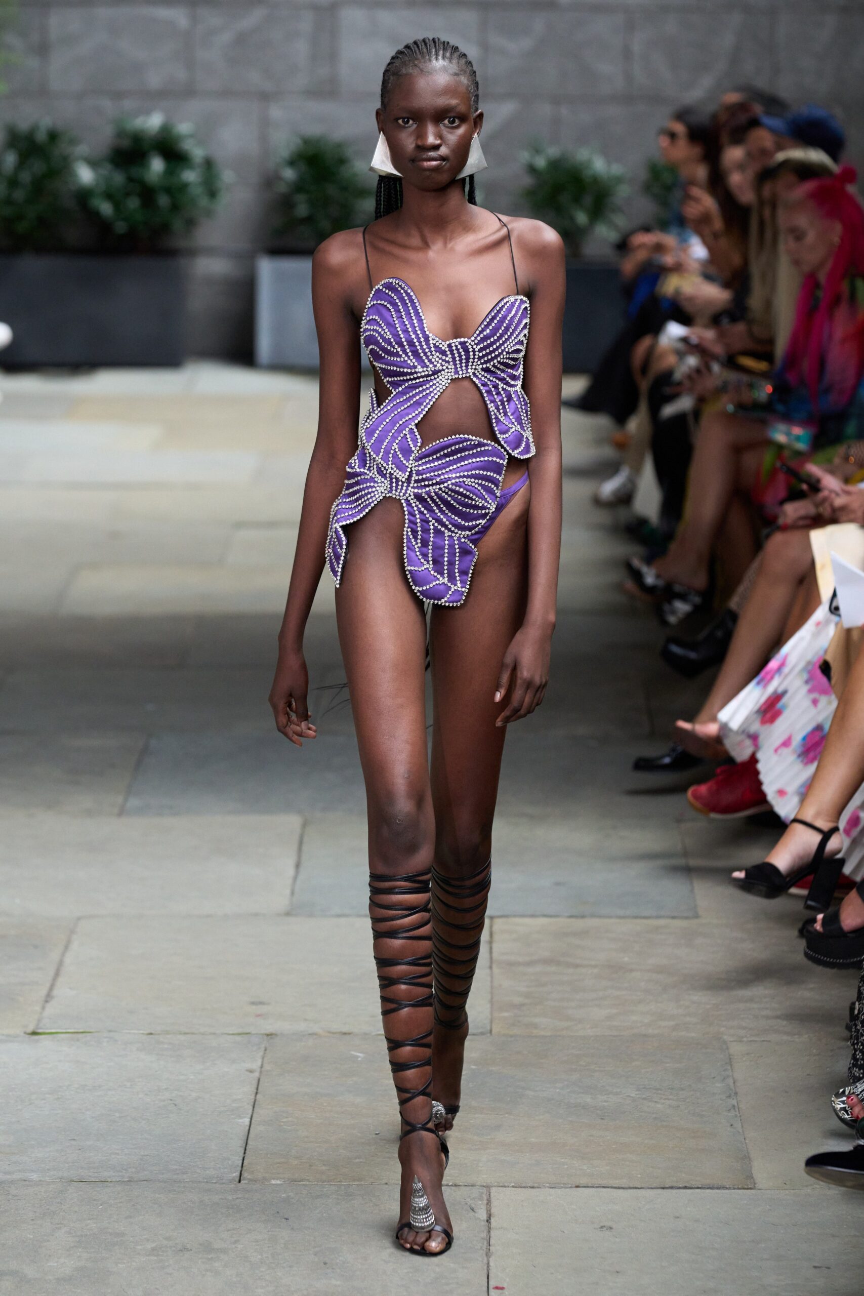purple beaded swimsuit with strappy shoes