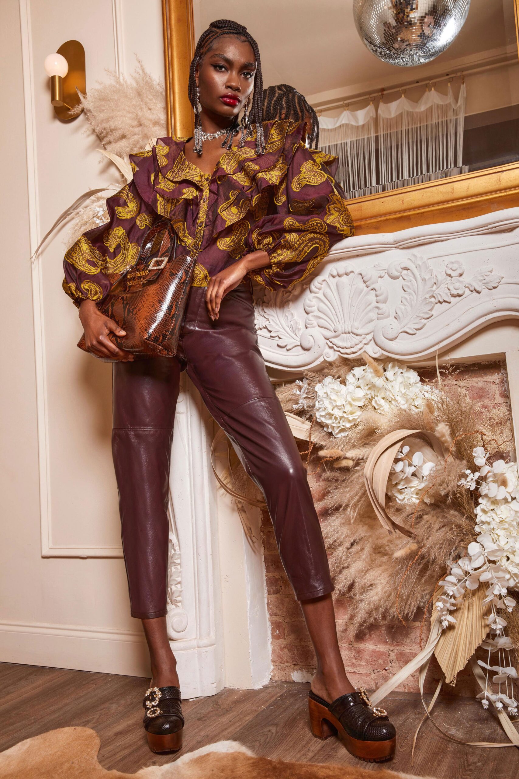 purple gold ruffled blouse with leather pants