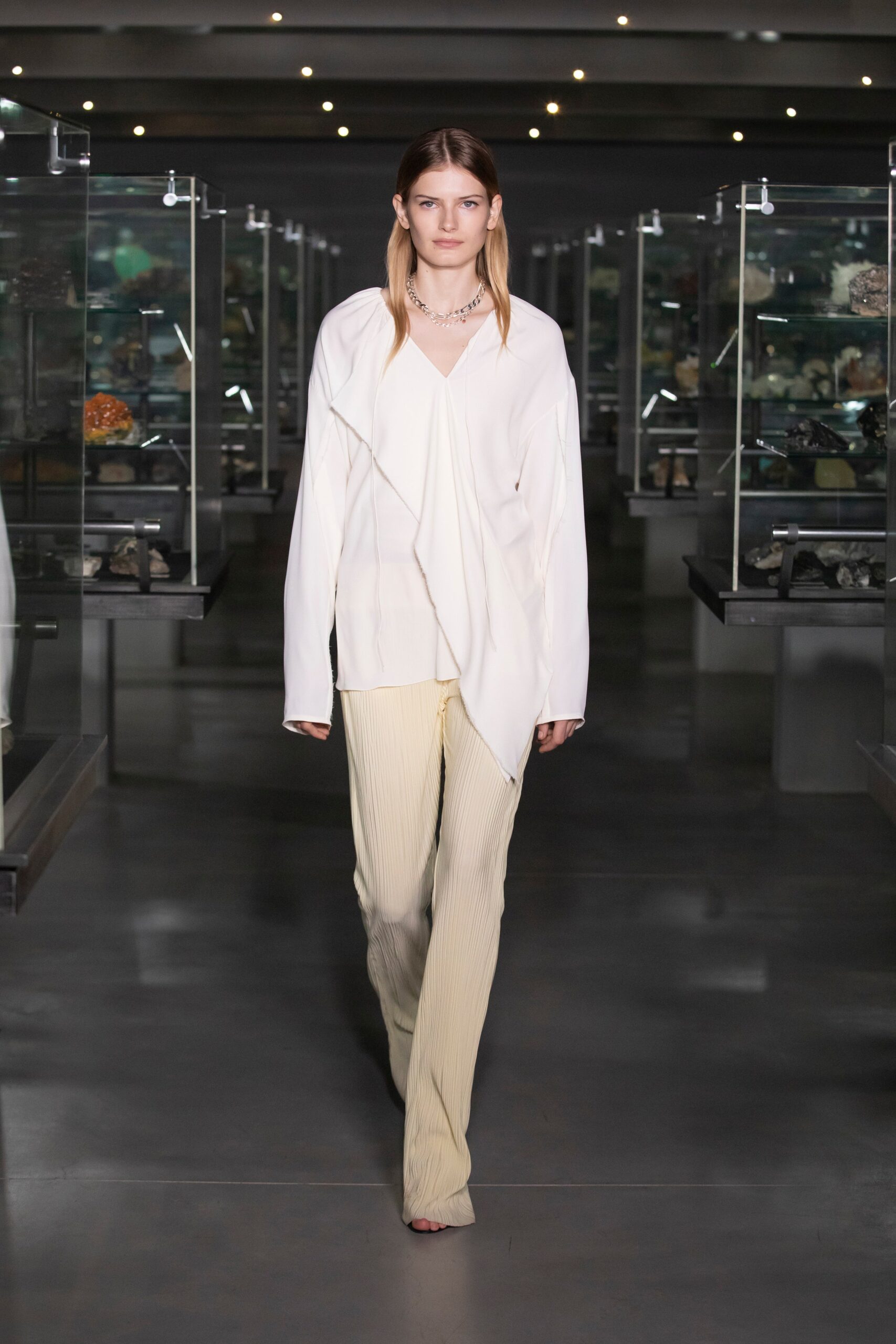 white silk relaxed blouse and beige pants
